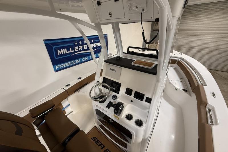 2026 Sea Pro 242 Center Console boat interior with steering and controls.