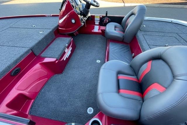 2026 Nitro Z17 boat interior with gray and red seating, carpeted flooring.