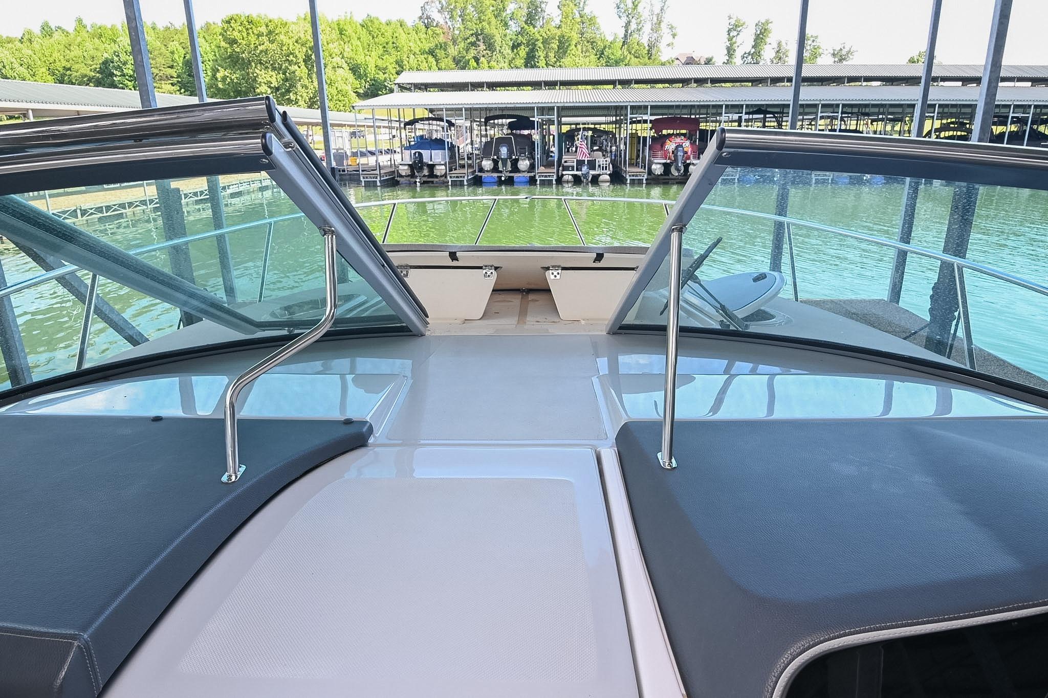2021 Regal 33 Express boat with open windshield, docked at marina.