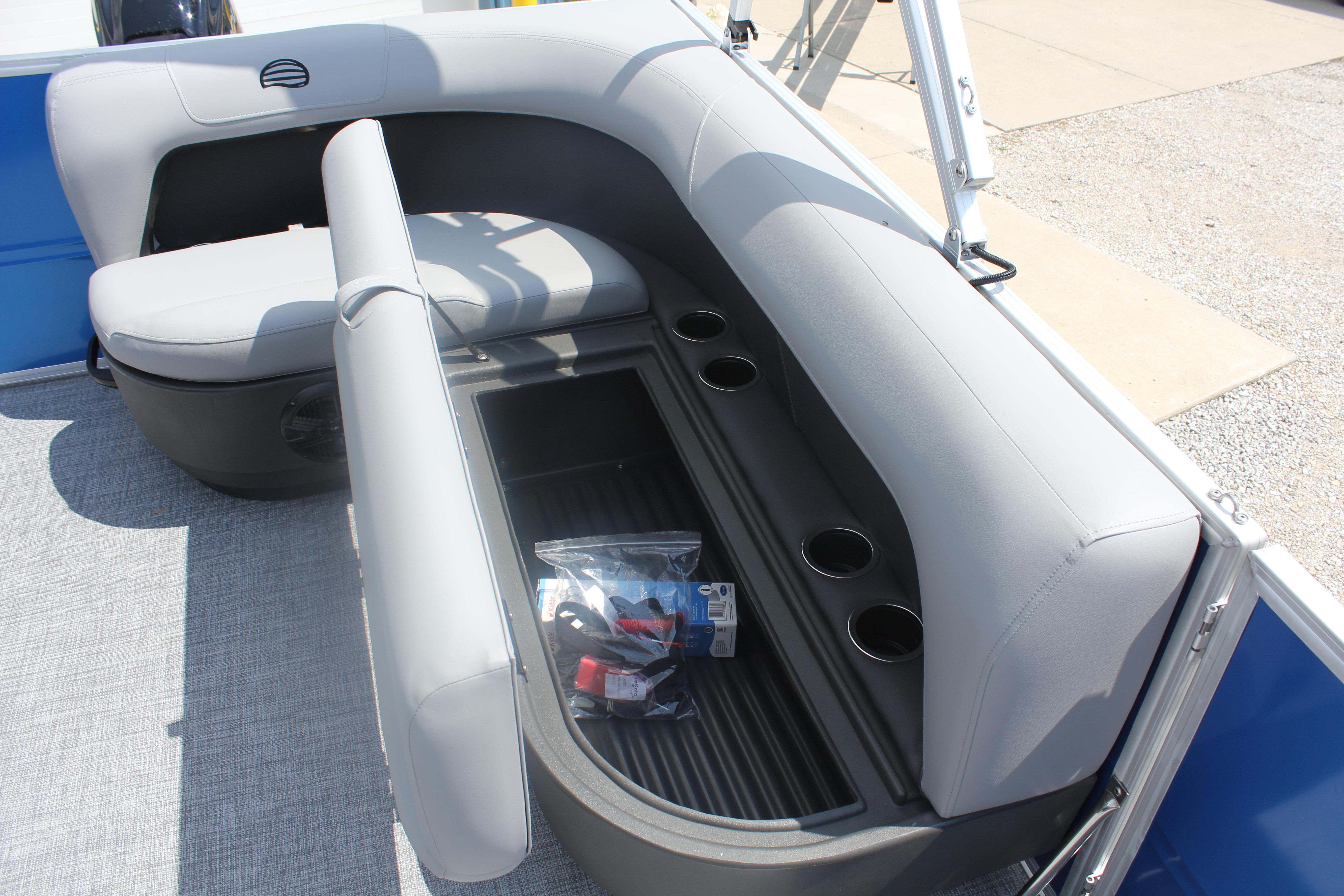 2026 Sun Tracker Party Barge 16 DLX seating area with storage and cup holders.