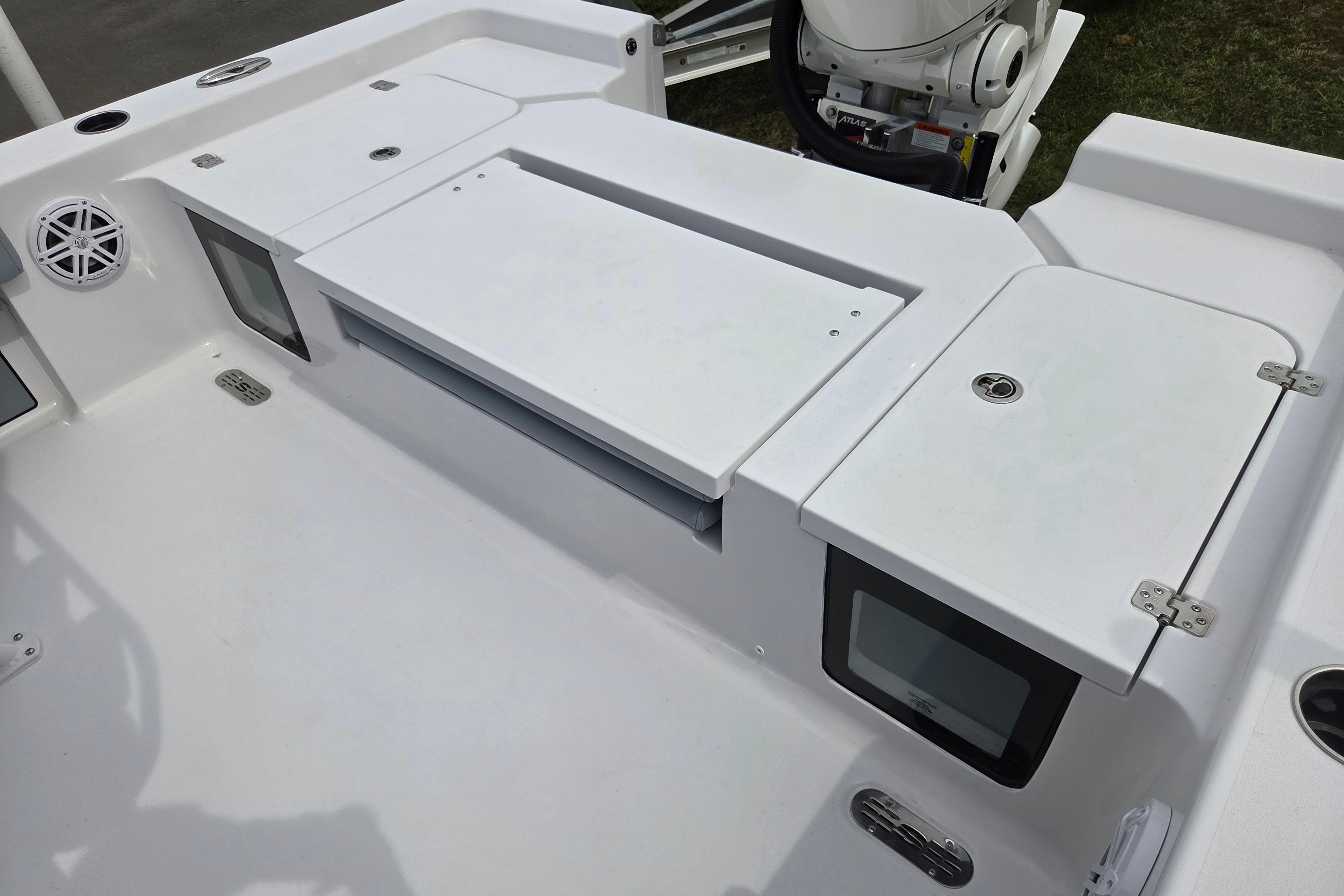 2026 Sportsman Masters 247OE Bay Boat deck with storage compartments and speaker.