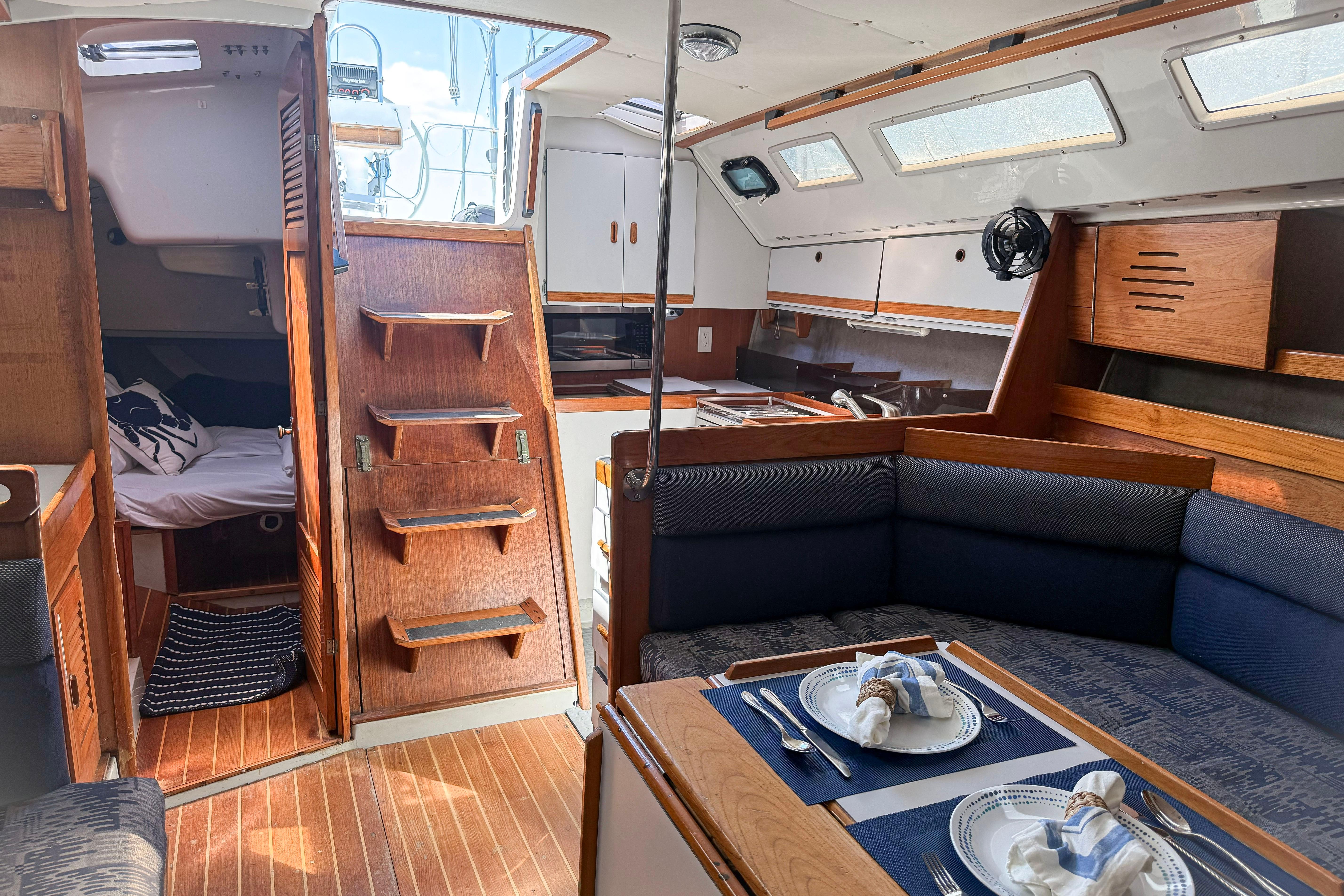 Interior of a 1988 Oday 40 sailboat with cozy dining and sleeping areas.