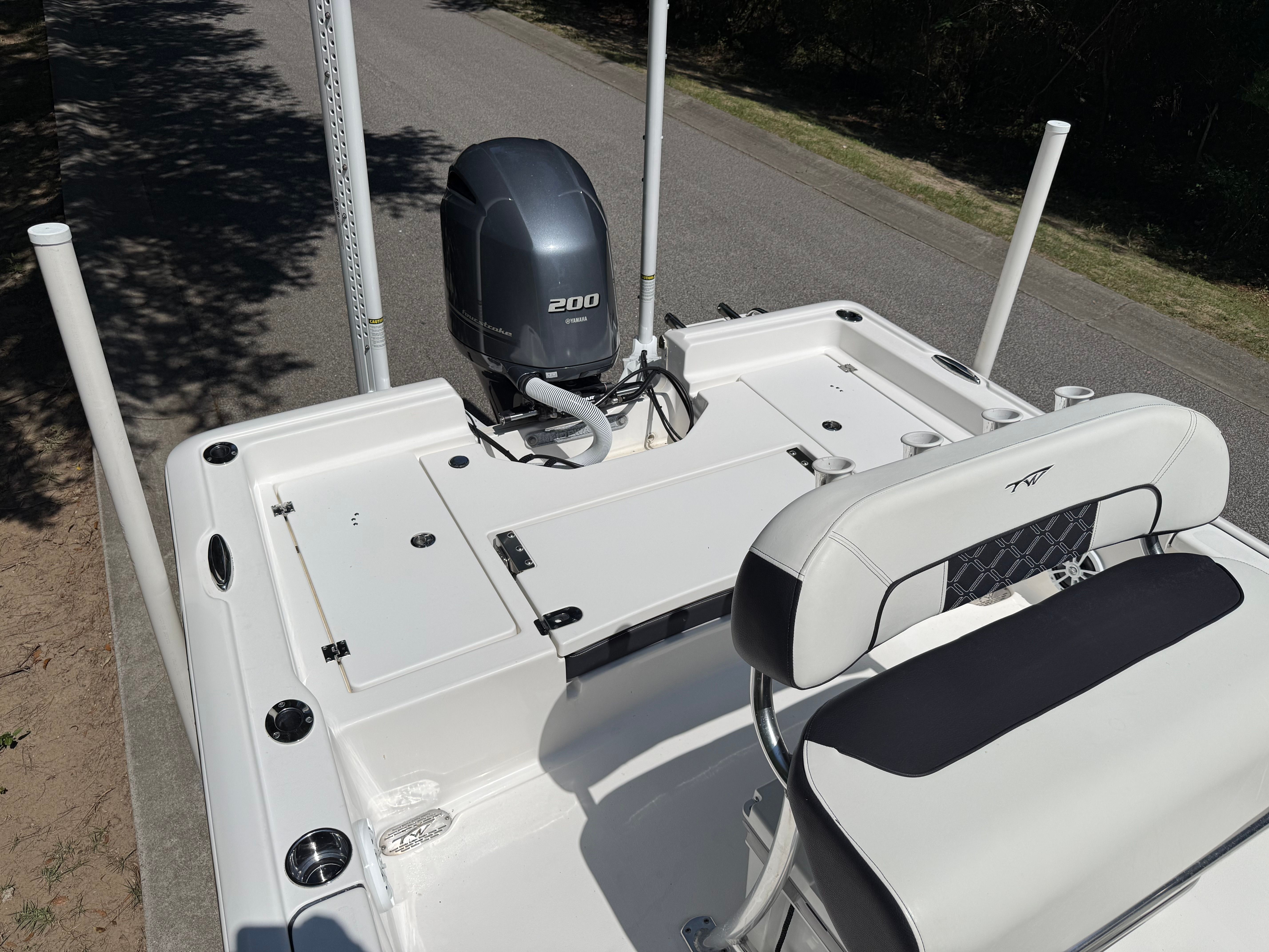 The image shows the stern of a Tidewater 2210 Carolina Bay boat with an outboard motor.