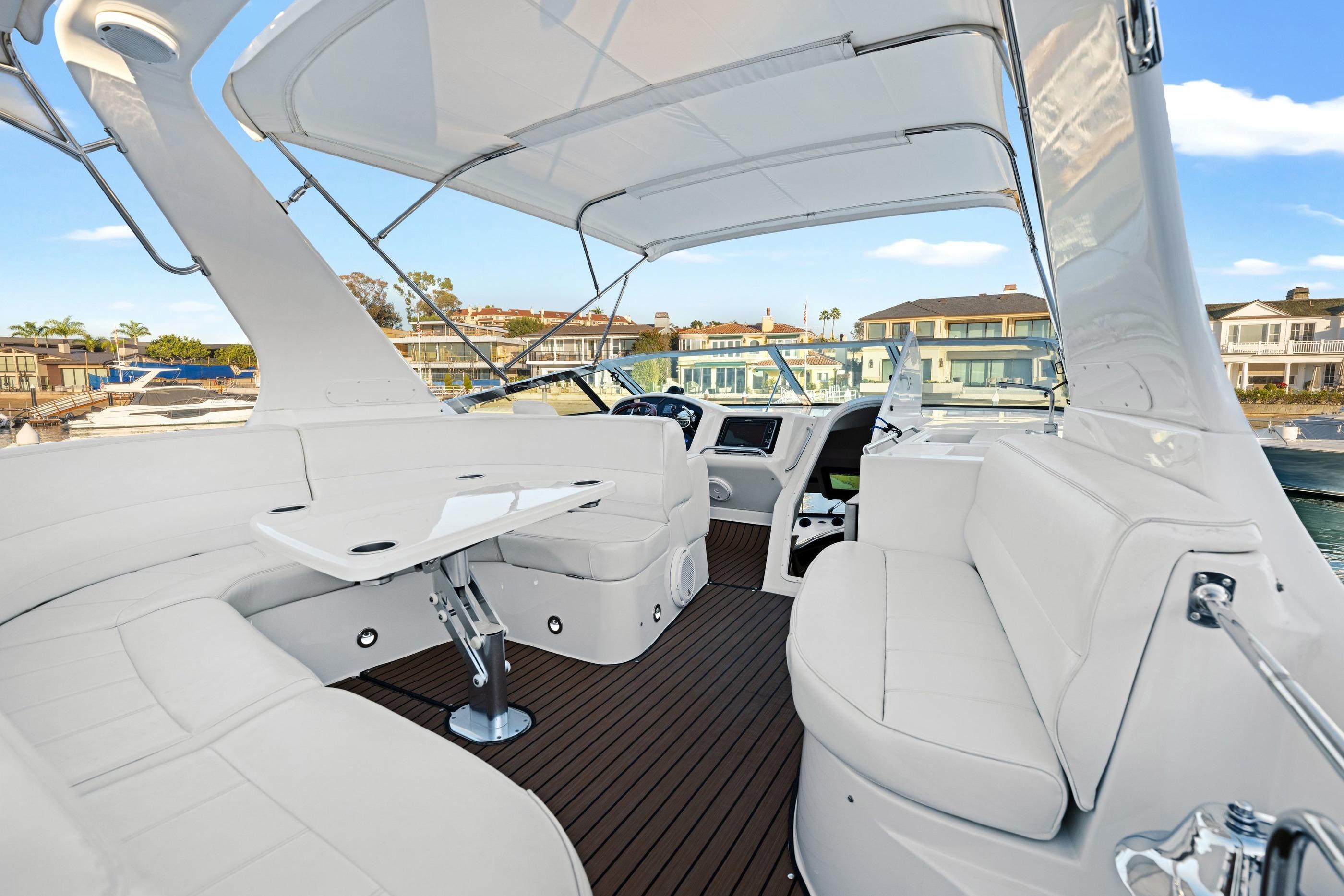 Luxurious 1999 Carver 53 Voyager yacht interior with white seating and modern design.