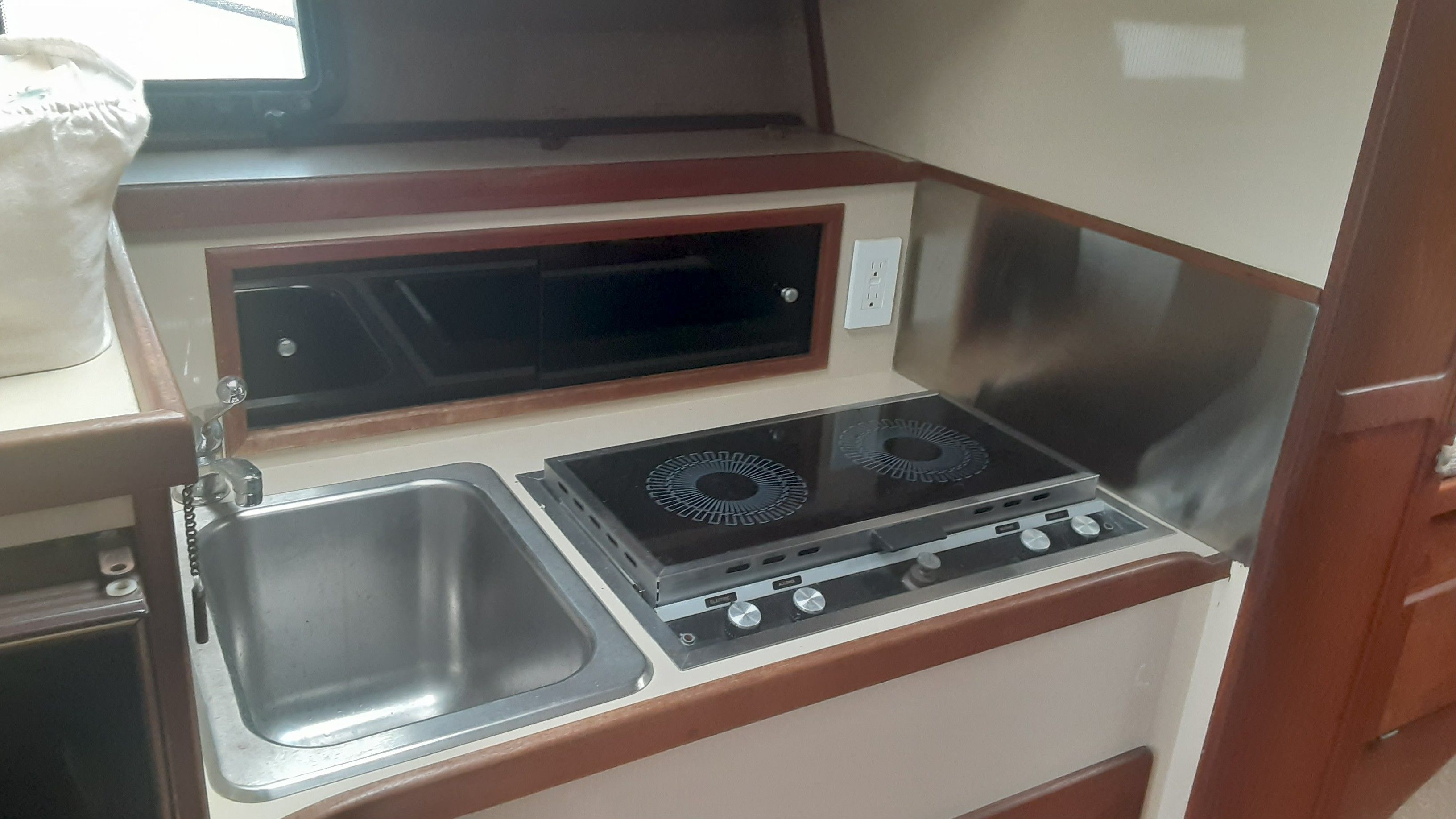 1985 Tiara Yachts 3100 Open kitchen area with stove and sink.