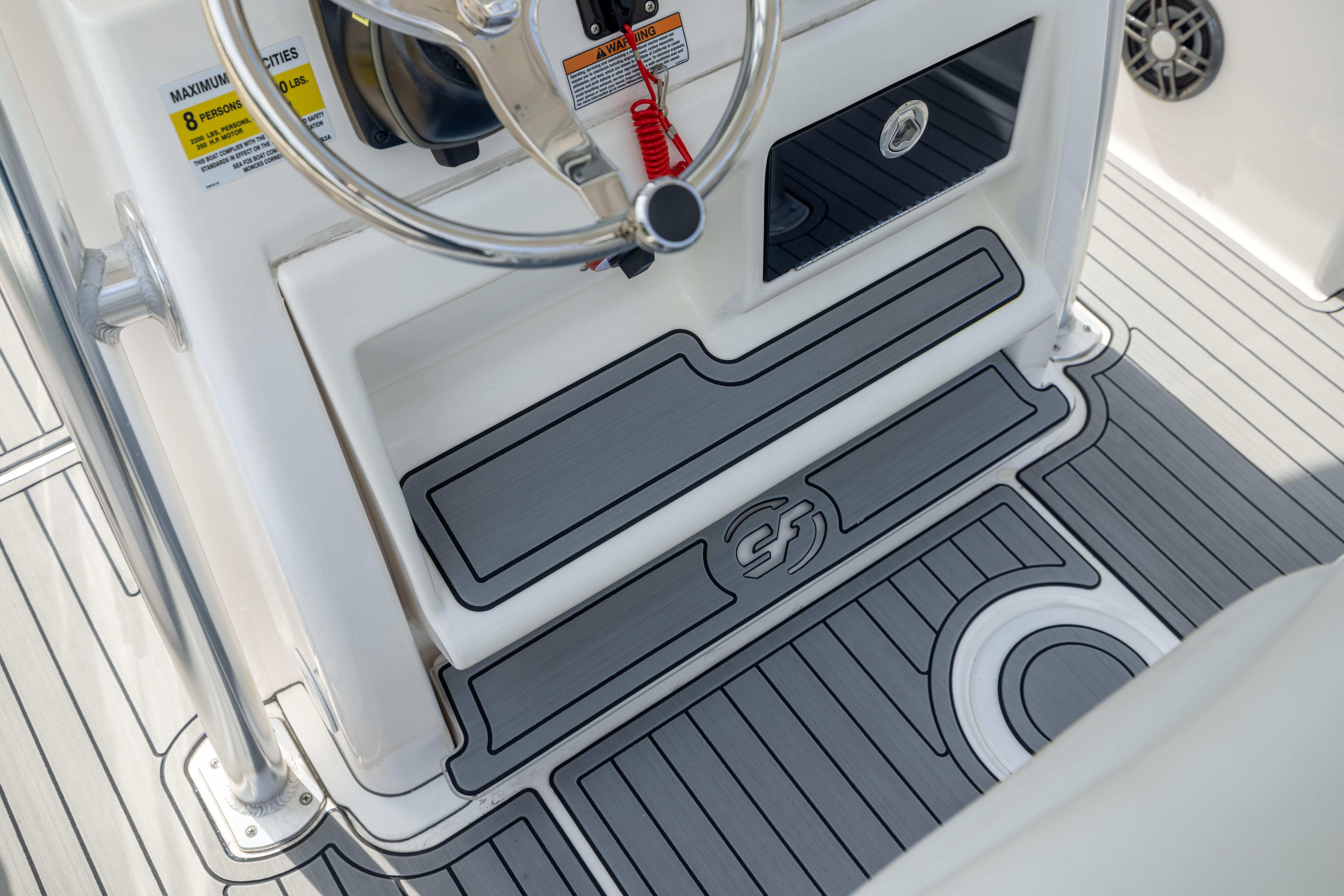 2023 Sea Fox 228 Commander boat interior with steering wheel and non-slip flooring.