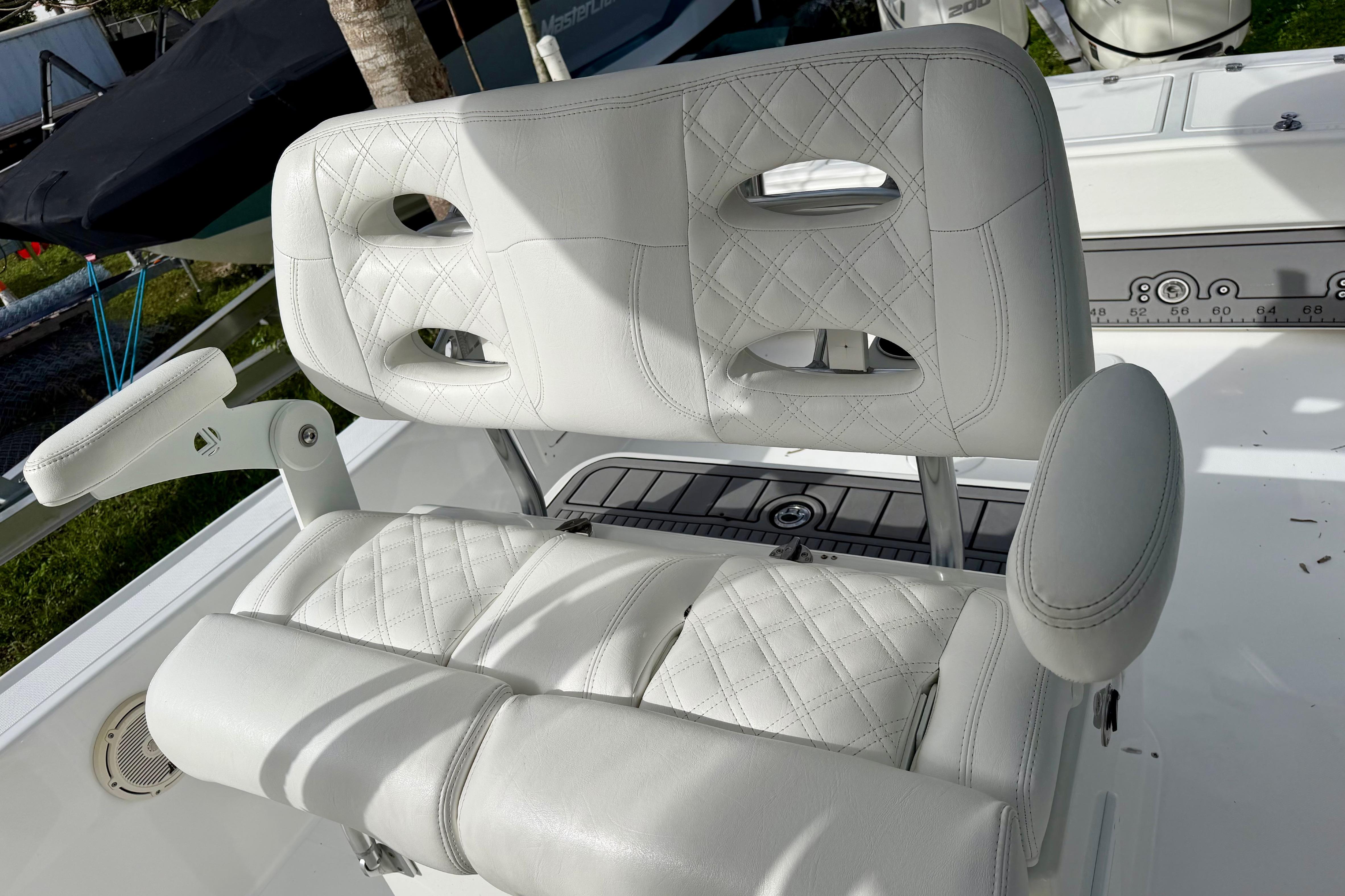 Luxury seating on 2025 Ocean Master 296 Center Console boat, featuring white quilted upholstery.