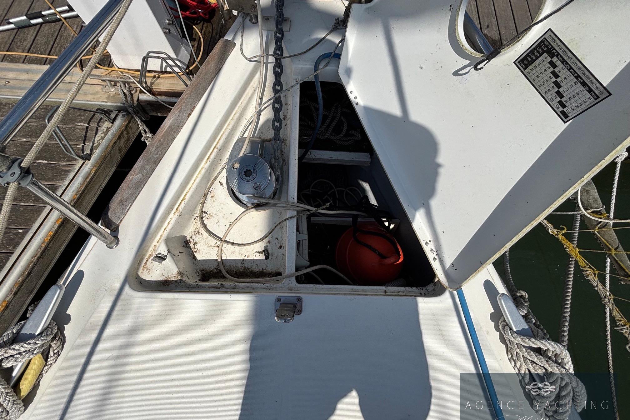 Deck view of a 2008 Beneteau Oceanis 40 sailboat, showing anchor chain and storage compartment.