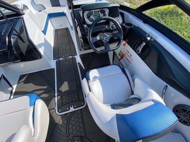 The image shows the cockpit of a 2024 Scarab 195 ID boat with modern seating and controls.
