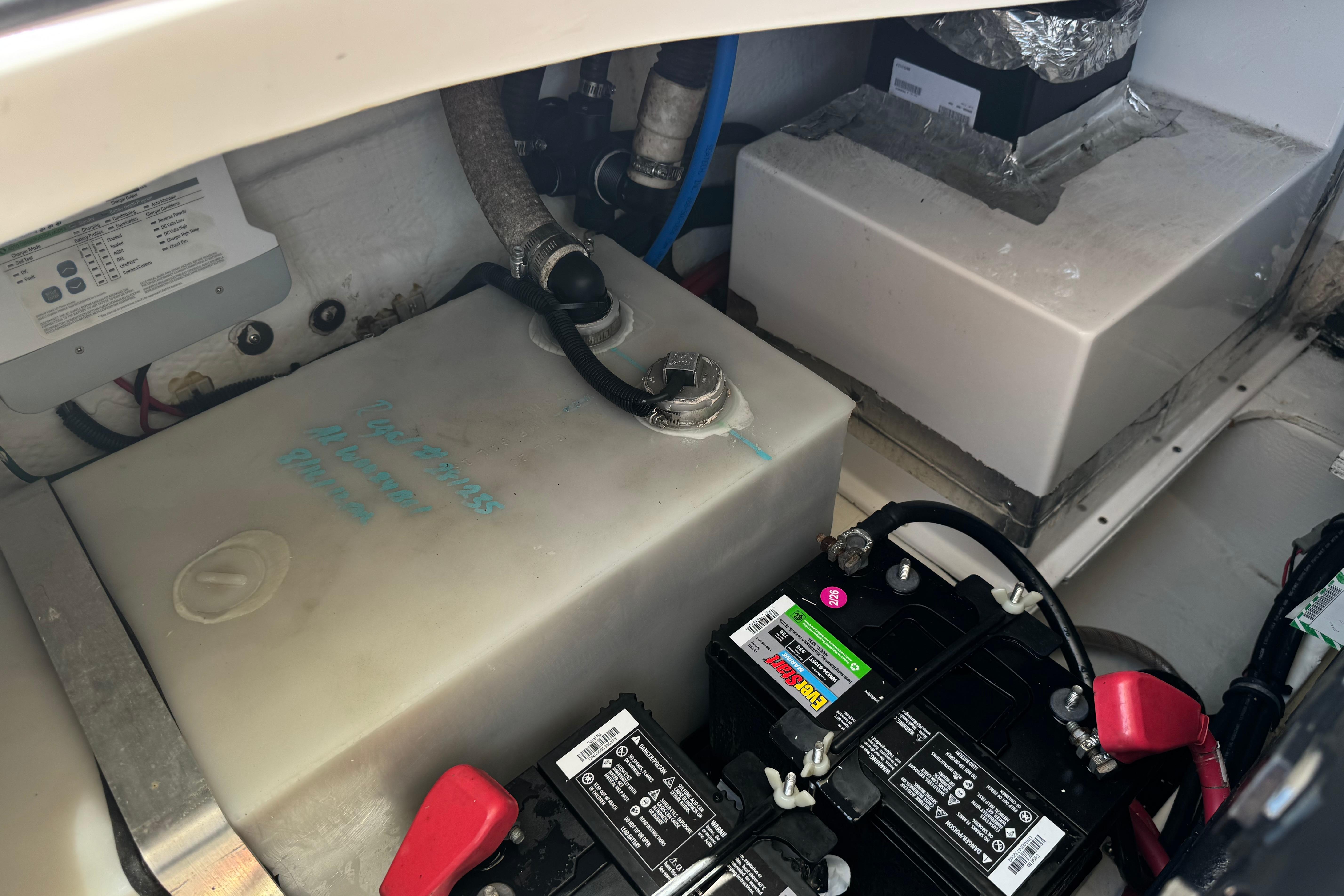 2013 Regal 28 Express engine compartment with battery and fluid tanks.
