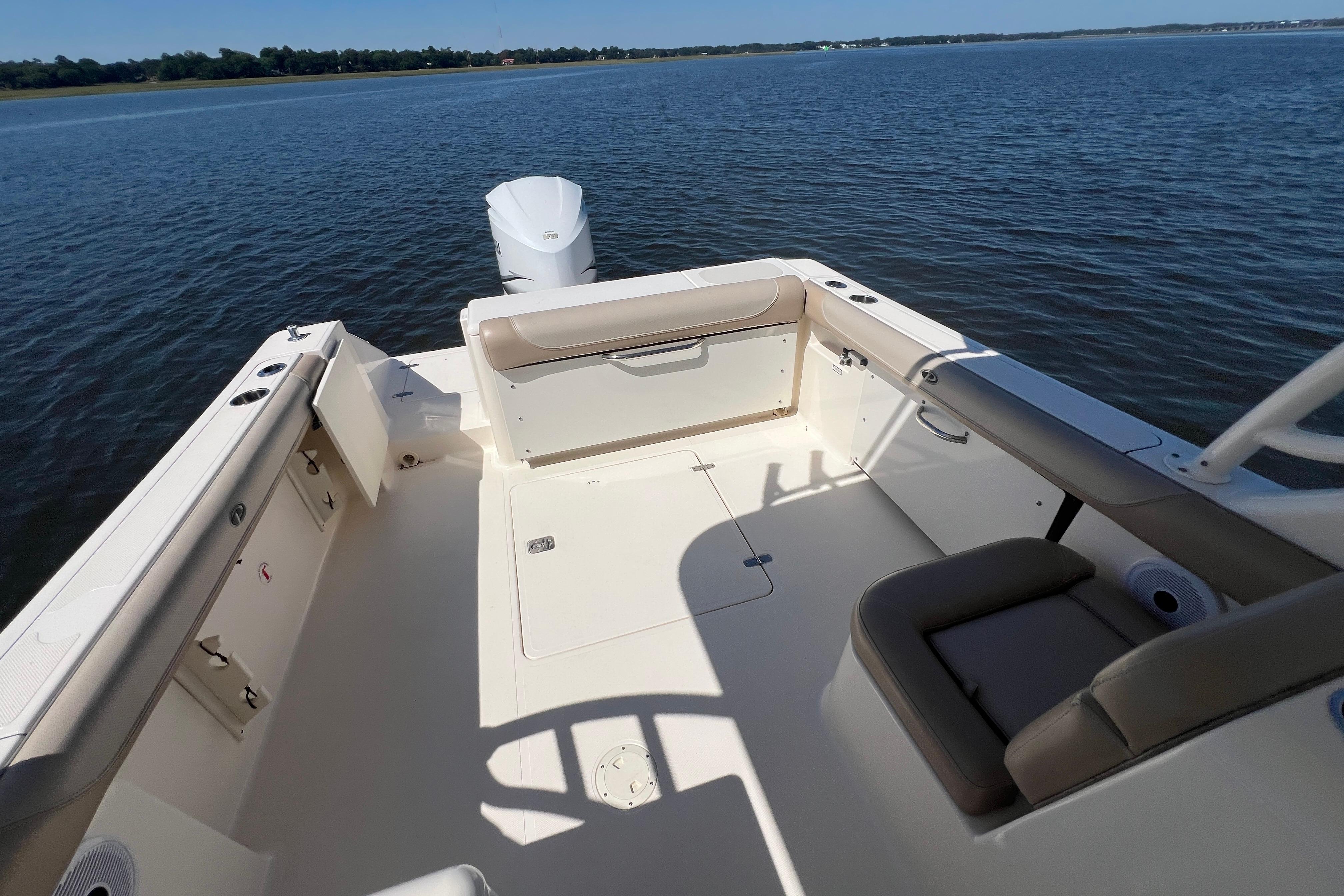 2011 Pursuit DC 265 Dual Console boat interior with seating, on calm water.