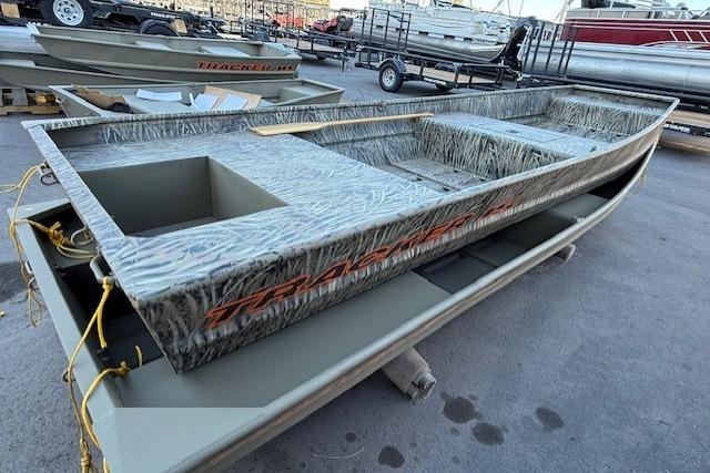 2026 Tracker Grizzly 15 Jon boat with camouflage design, displayed outdoors.