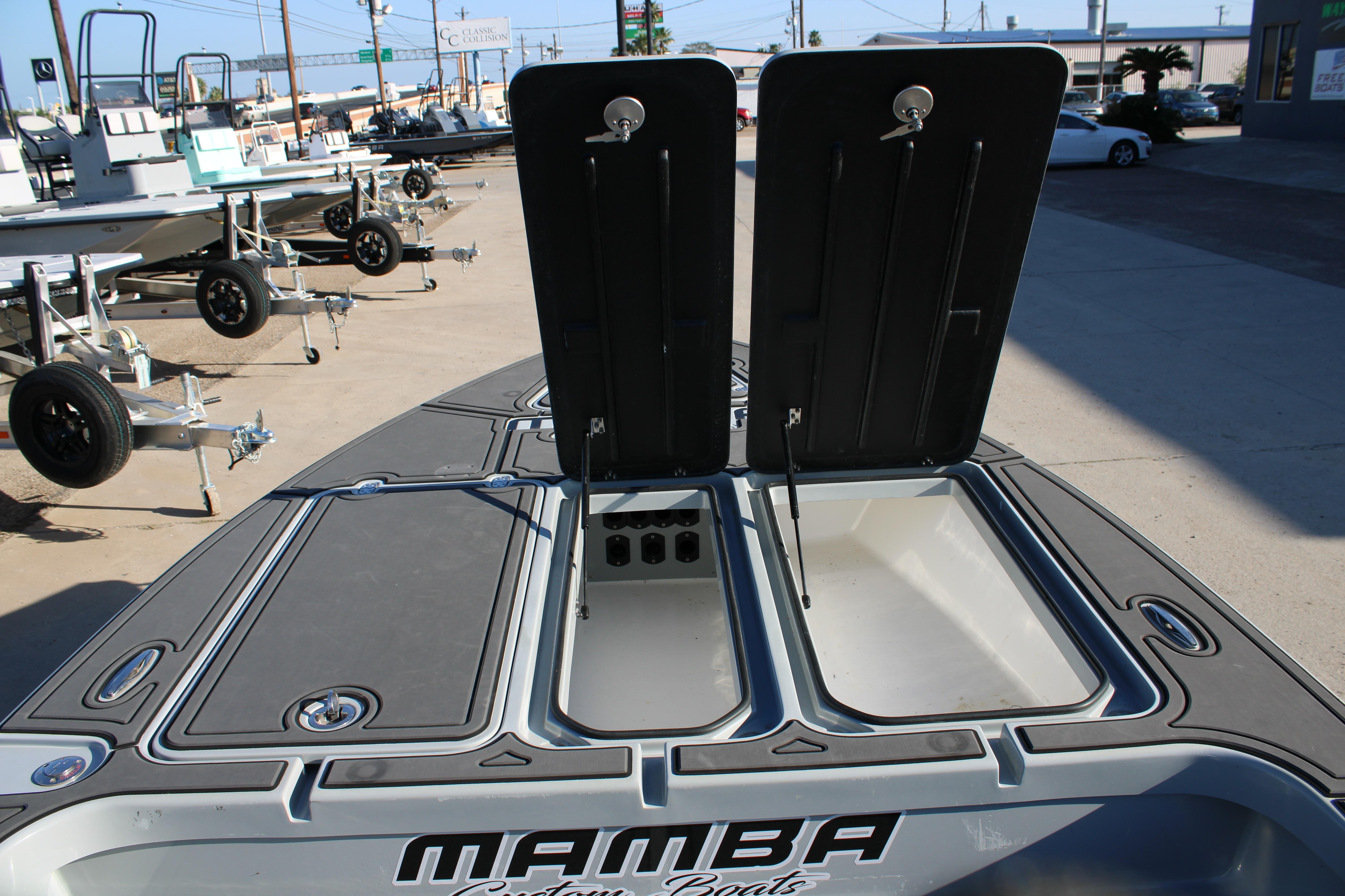 Open storage compartments on a 2025 Mamba 227VX boat, showcasing spacious design.