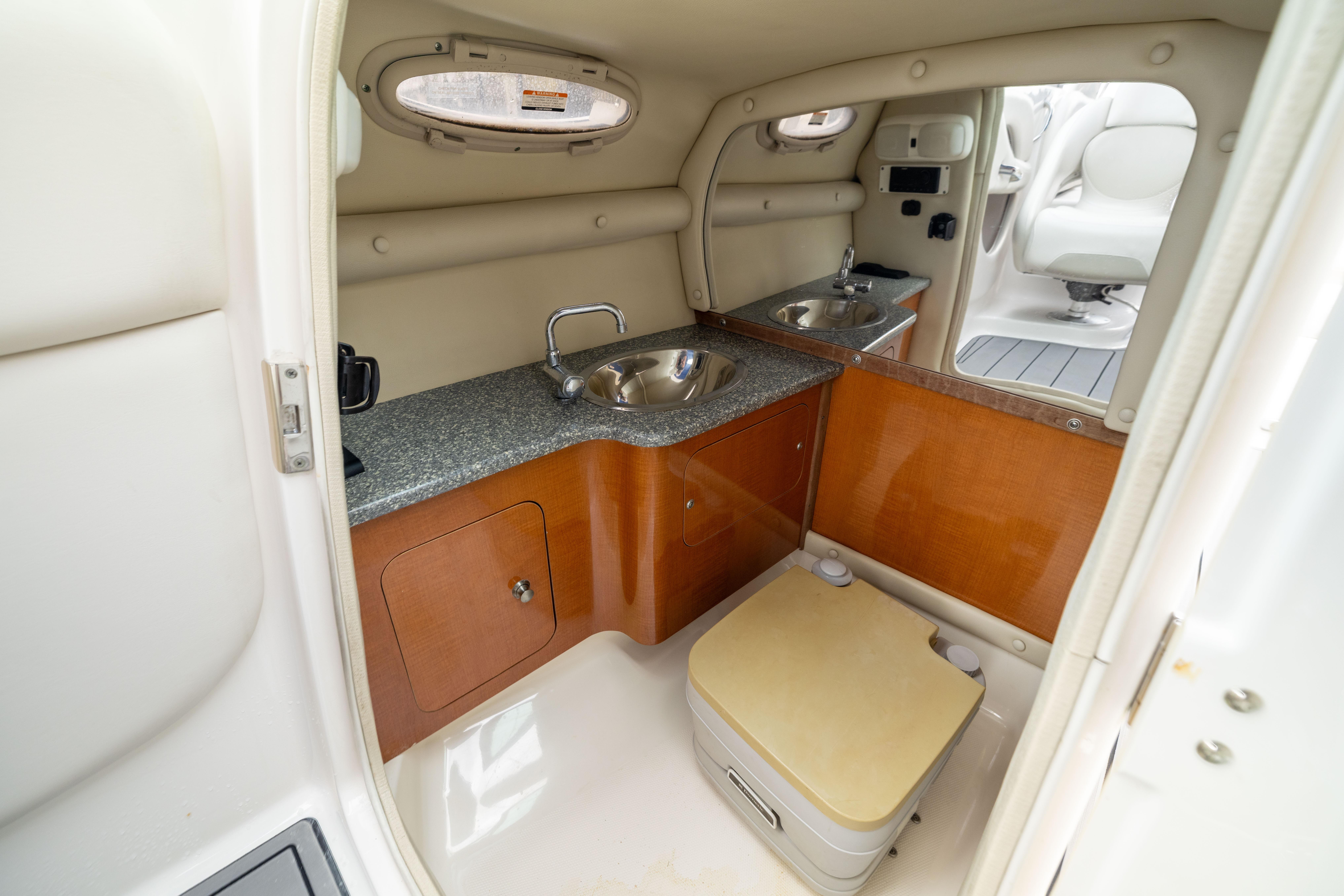 2008 Chaparral 256 SSi boat interior with sink, countertop, and storage.