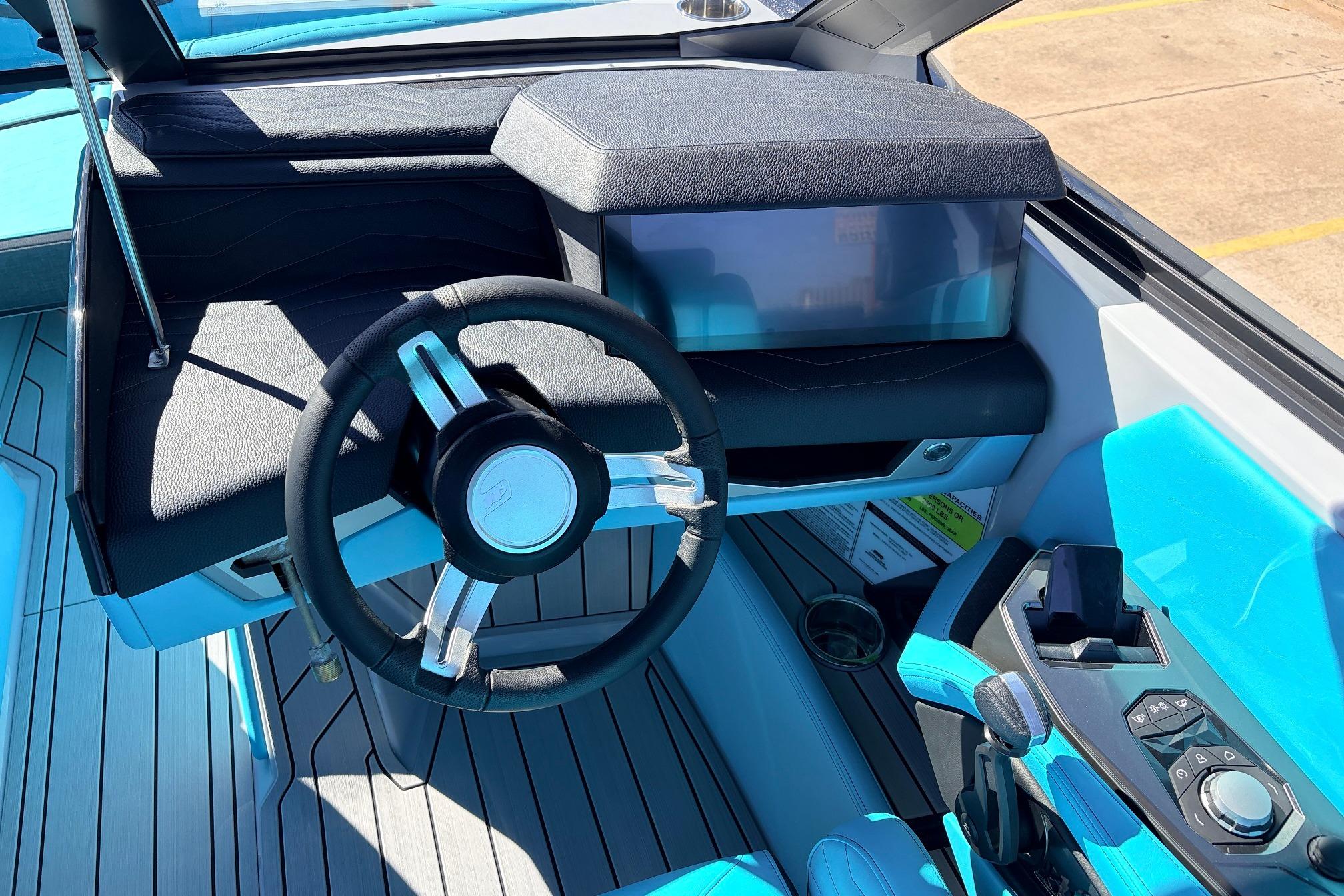 Interior of 2026 Nautique Super Air Nautique G23 boat with modern steering and controls.