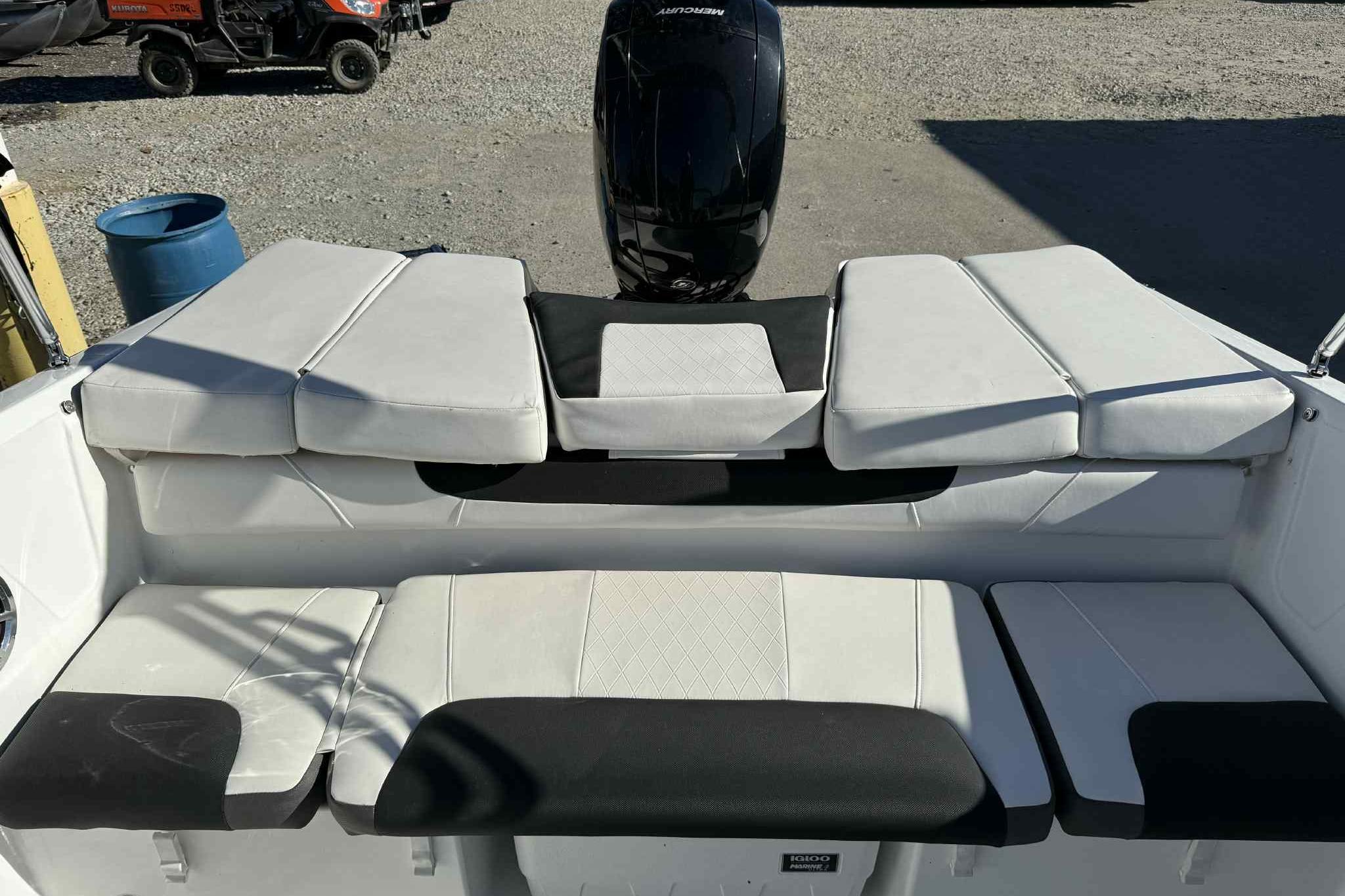 2021 Tahoe 550 TS boat interior with cushioned seating and outboard motor.