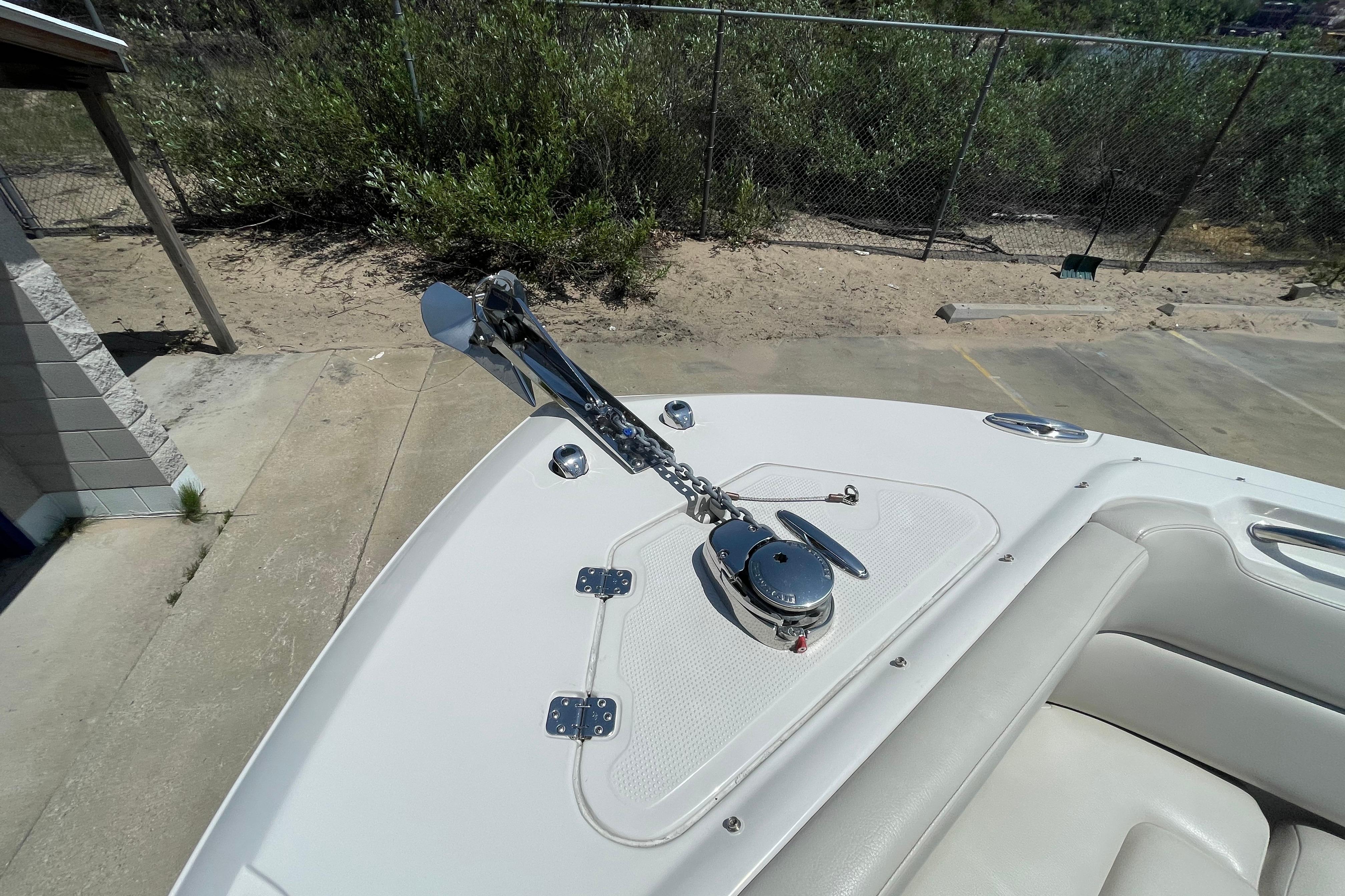 Bow view of 2022 Sailfish 245 DC boat with anchor and chain mechanism.