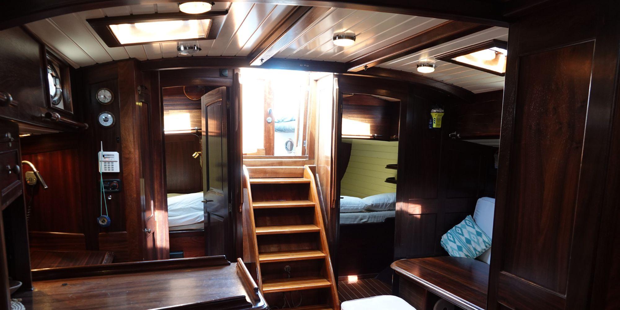 Interior of 2004 Joubert-Nivelt TM 52 yacht with wooden furnishings and cozy cabin layout.