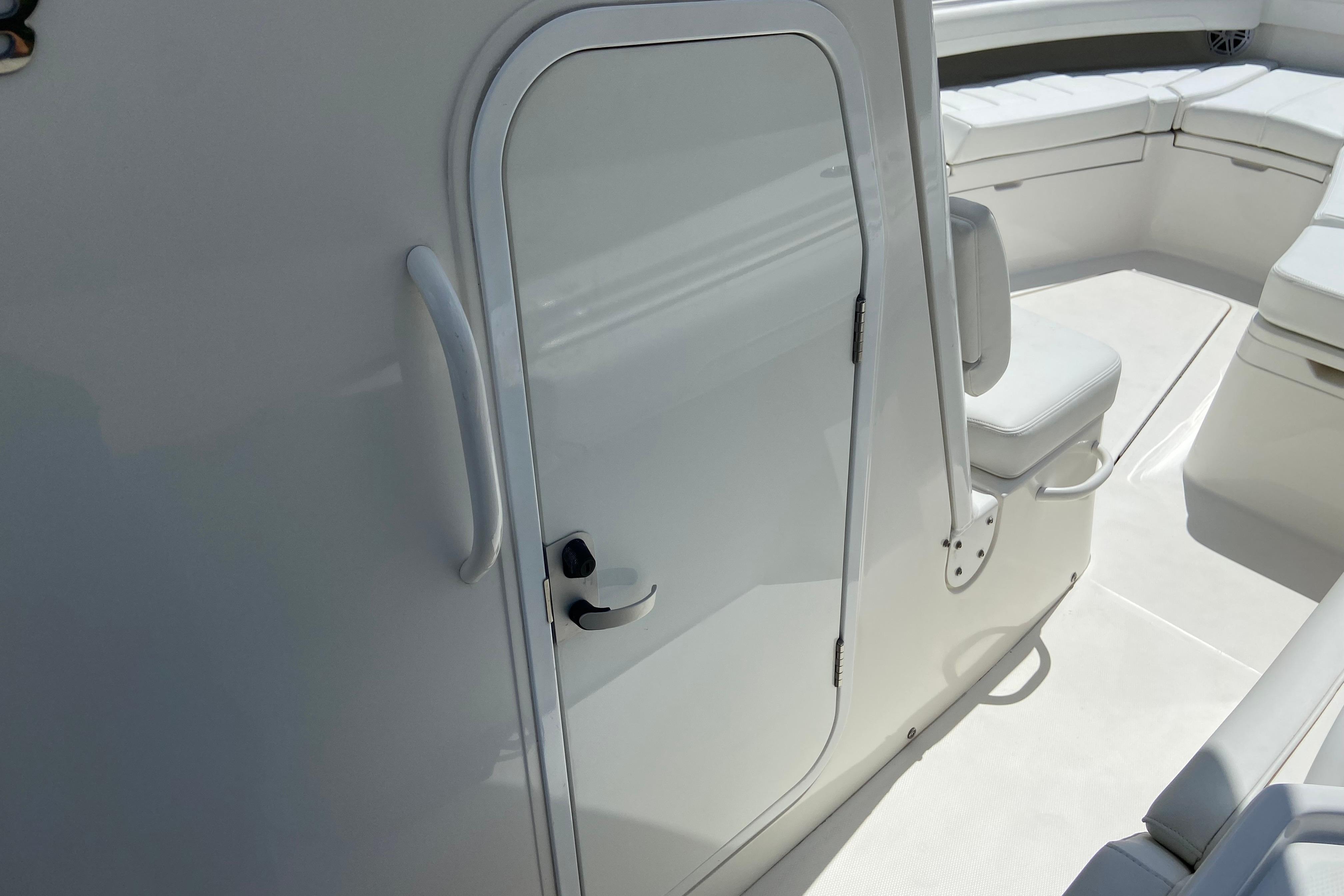 2021 Regulator 28 boat interior with white seating and cabin door.