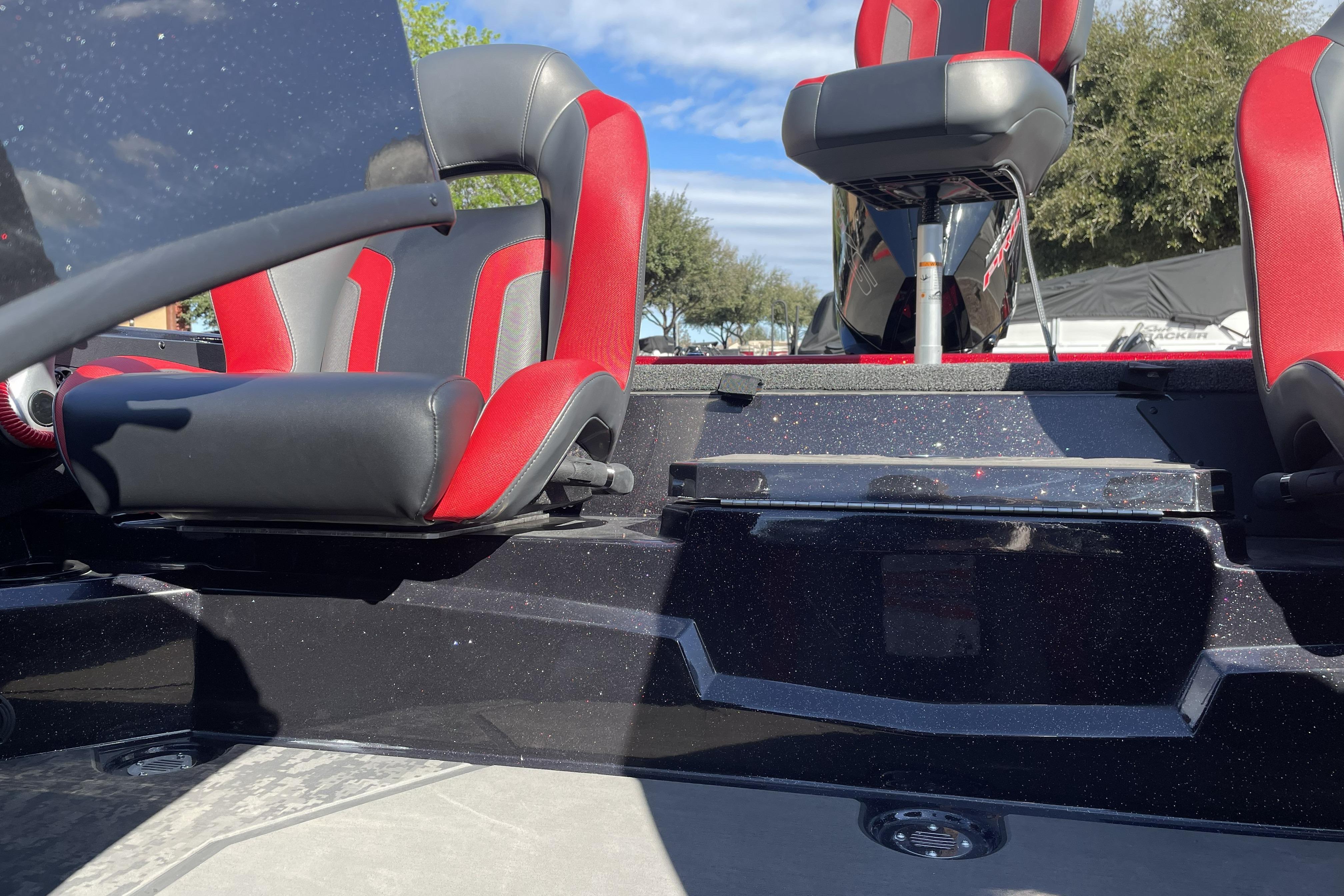 2026 Nitro Z19 XL boat interior with red and black seats, under clear blue sky.