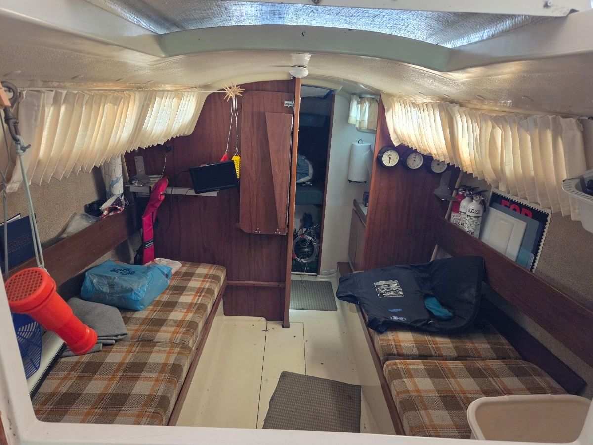 Interior of a 1979 O'Day Sloop with cozy seating area.