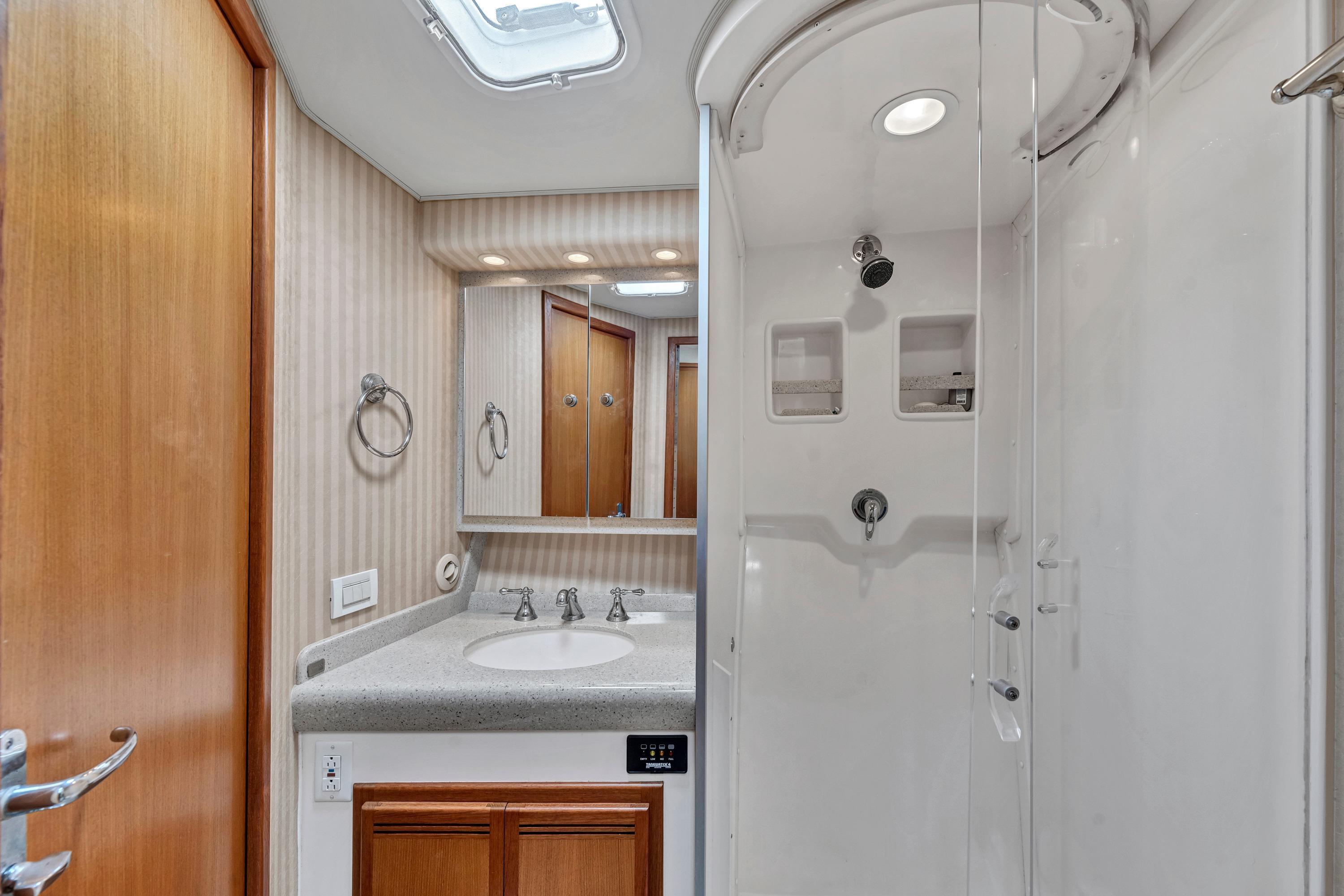 Luxurious 2010 Cabo 45 Express yacht bathroom with shower and vanity.