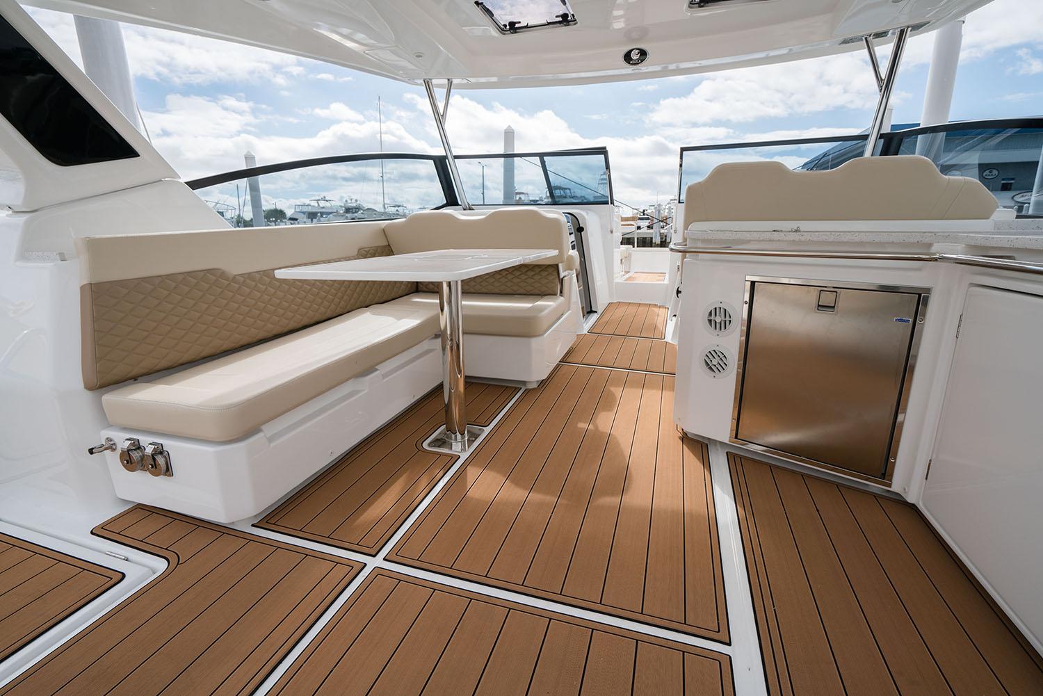 Manufacturer Provided Image: 2026 Aquila 36 Sport yacht interior with seating, table, and kitchenette.