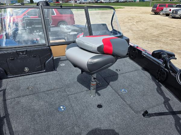 2025 Nitro ZV-20 SPORT boat interior with gray and red seating on a carpeted deck.