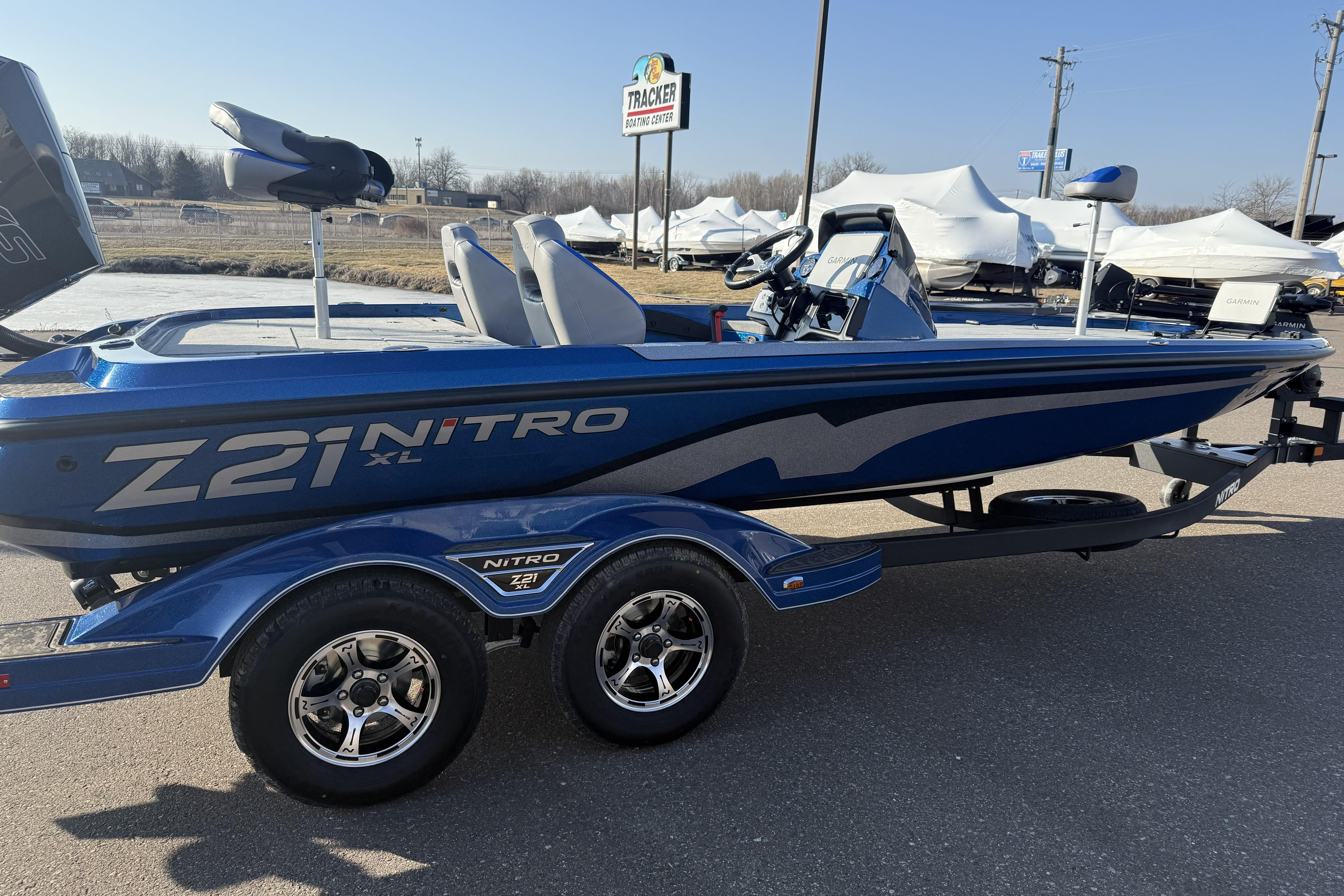 2026 Nitro Z21 XL Pro boat in blue, parked on a trailer outdoors.
