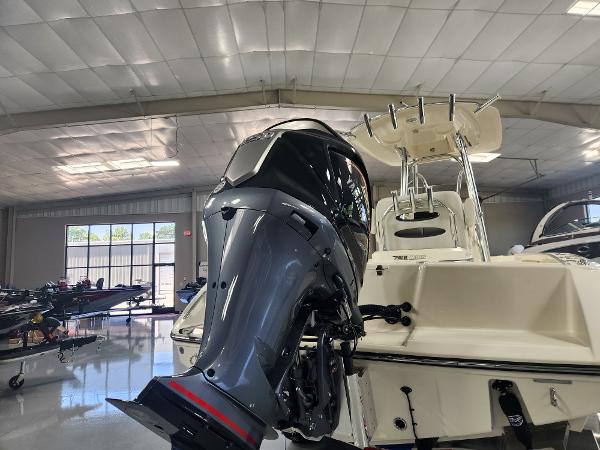 2025 Pathfinder 2400 Open boat with powerful outboard motor in showroom.