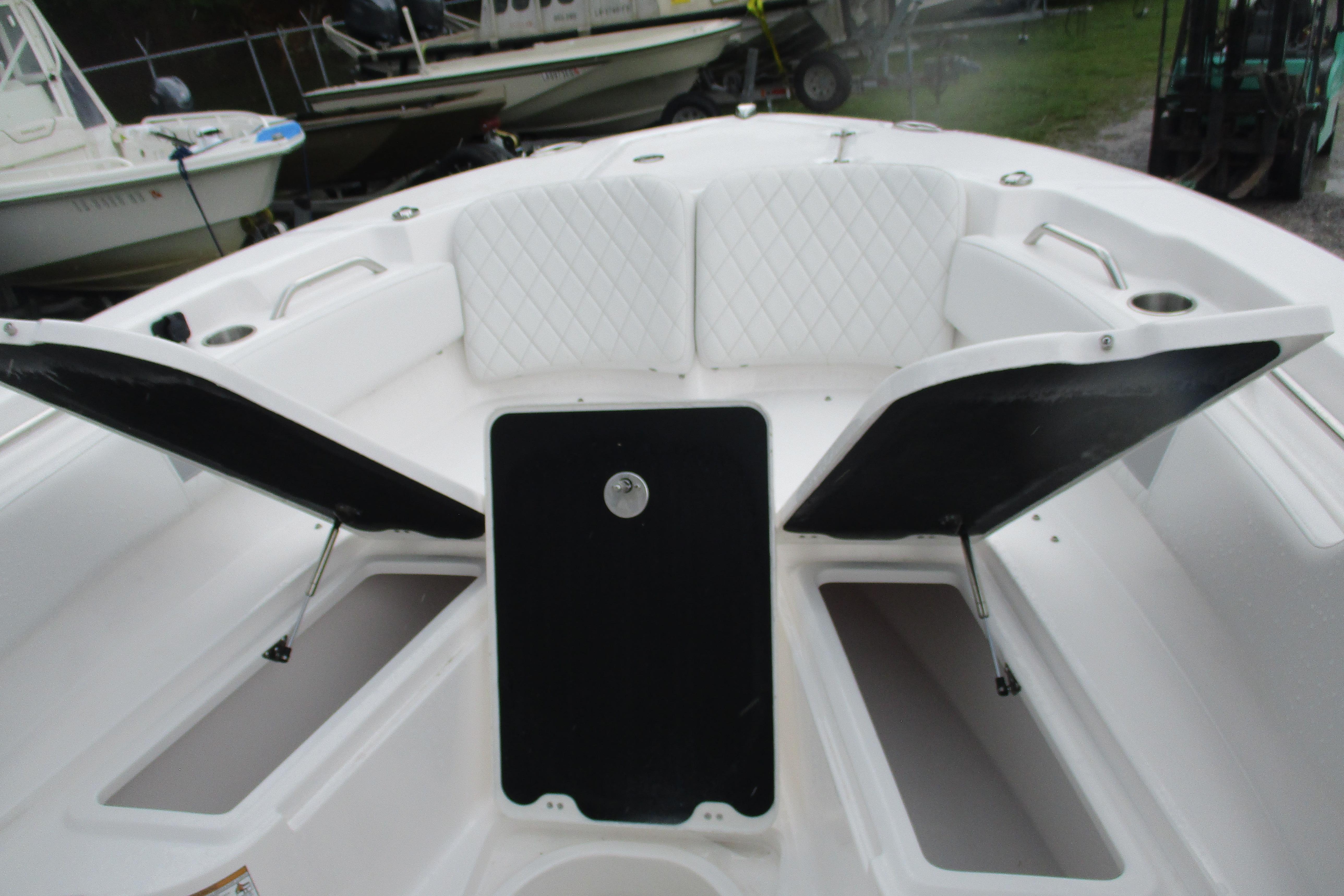 2026 Sea Fox 248 Commander boat interior with open storage compartments and cushioned seating.