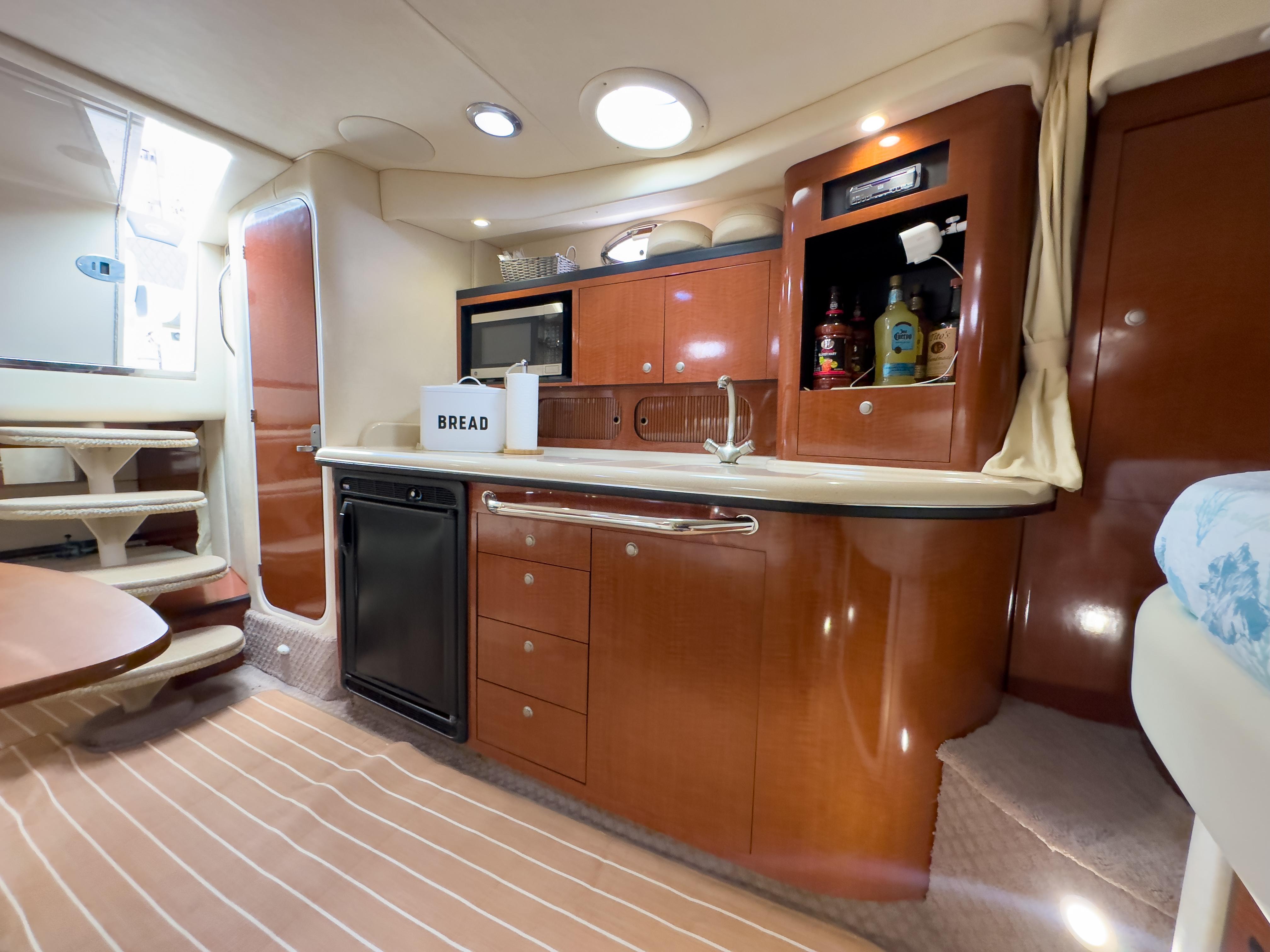 Luxurious 2005 Sea Ray 340 Sundancer yacht interior with modern kitchen amenities.