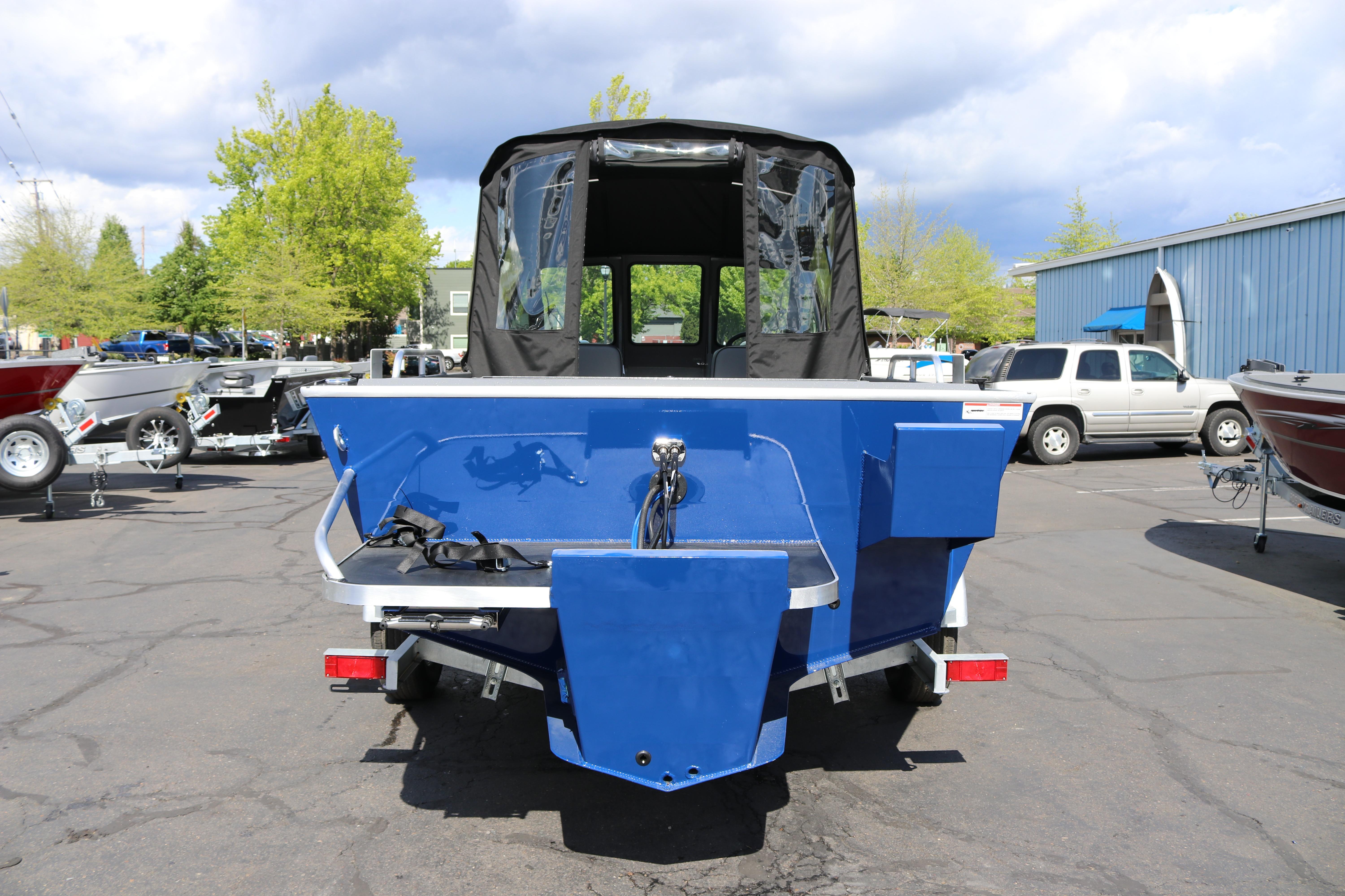 2025 Alumaweld Stryker X202 boat, blue exterior, parked outdoors on a sunny day.