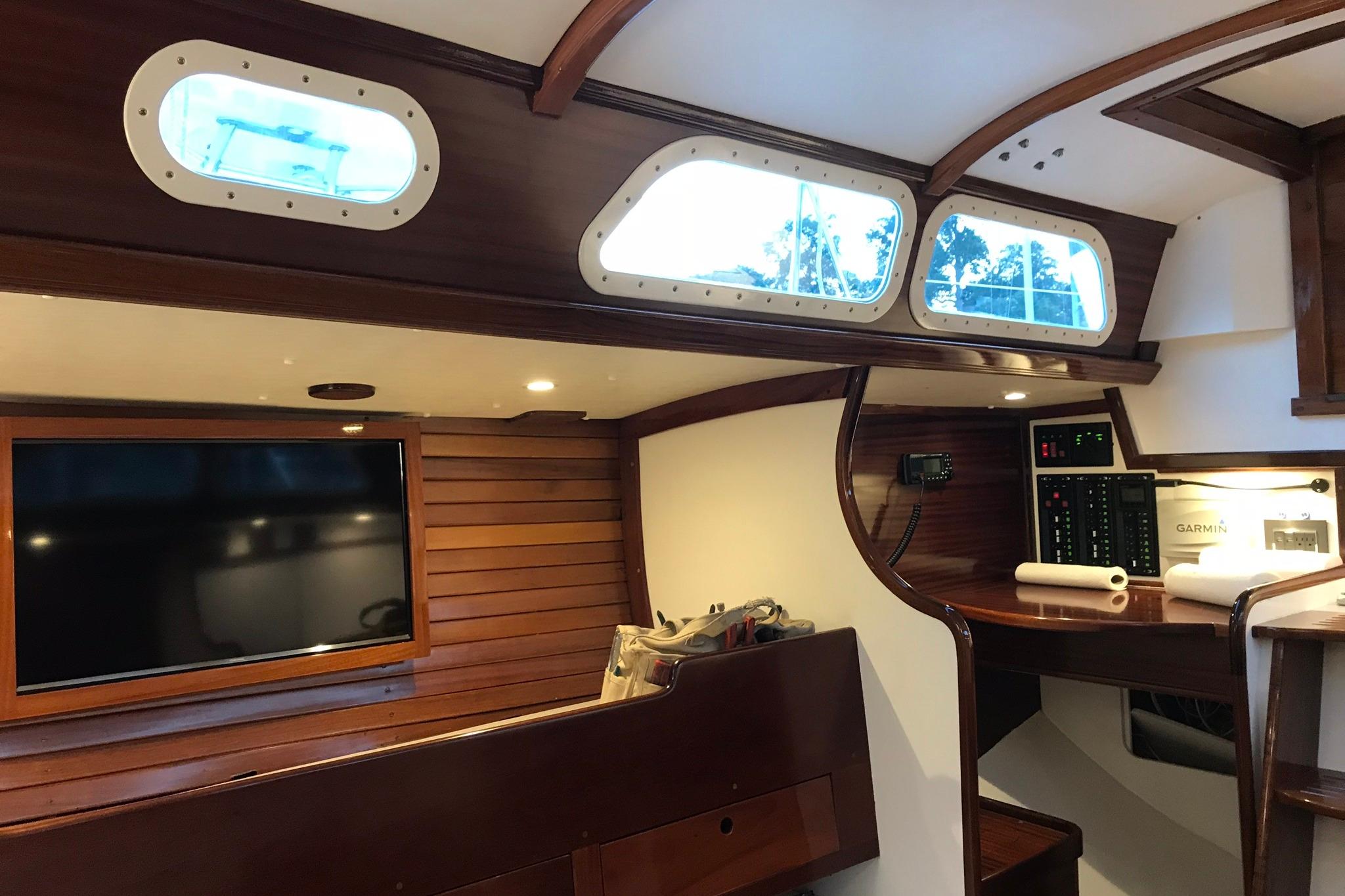 Interior of a 1970 Hinckley Bermuda 40 sailboat with wood paneling and navigation equipment.