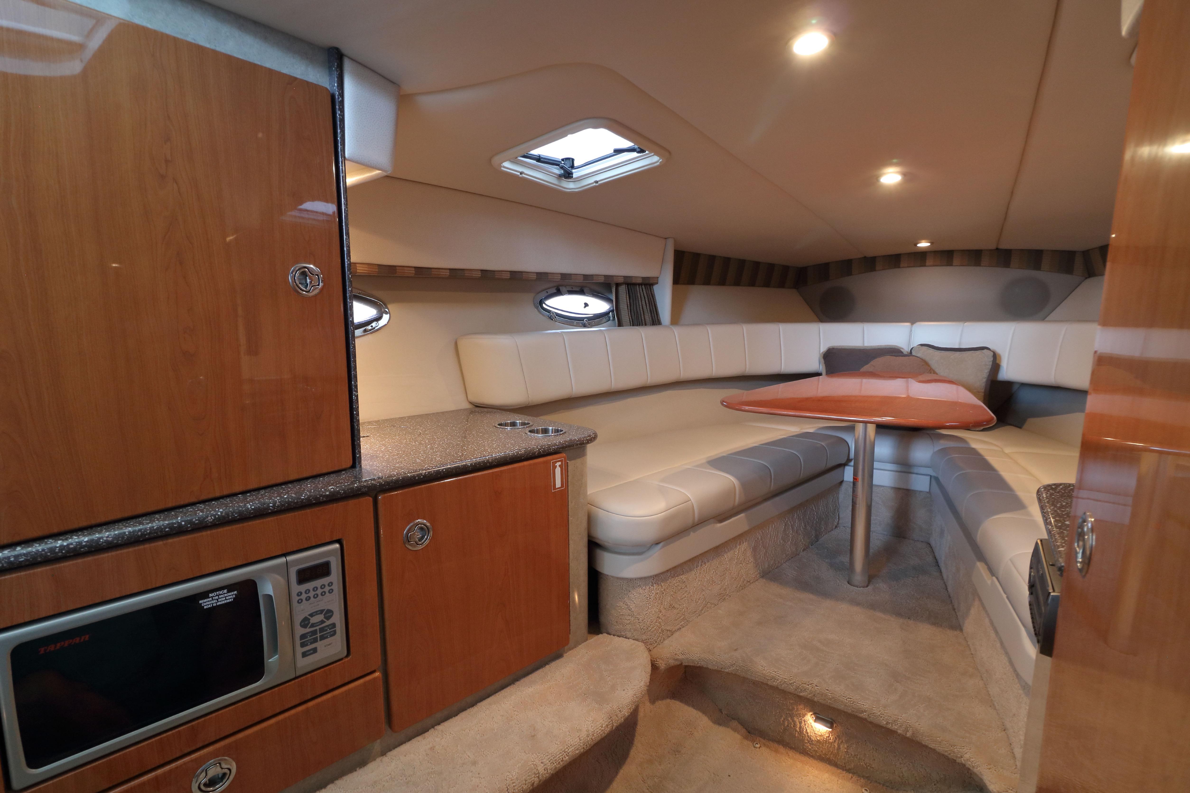 Luxurious interior of a 2006 Formula 330 Sun Sport boat with seating and kitchenette.