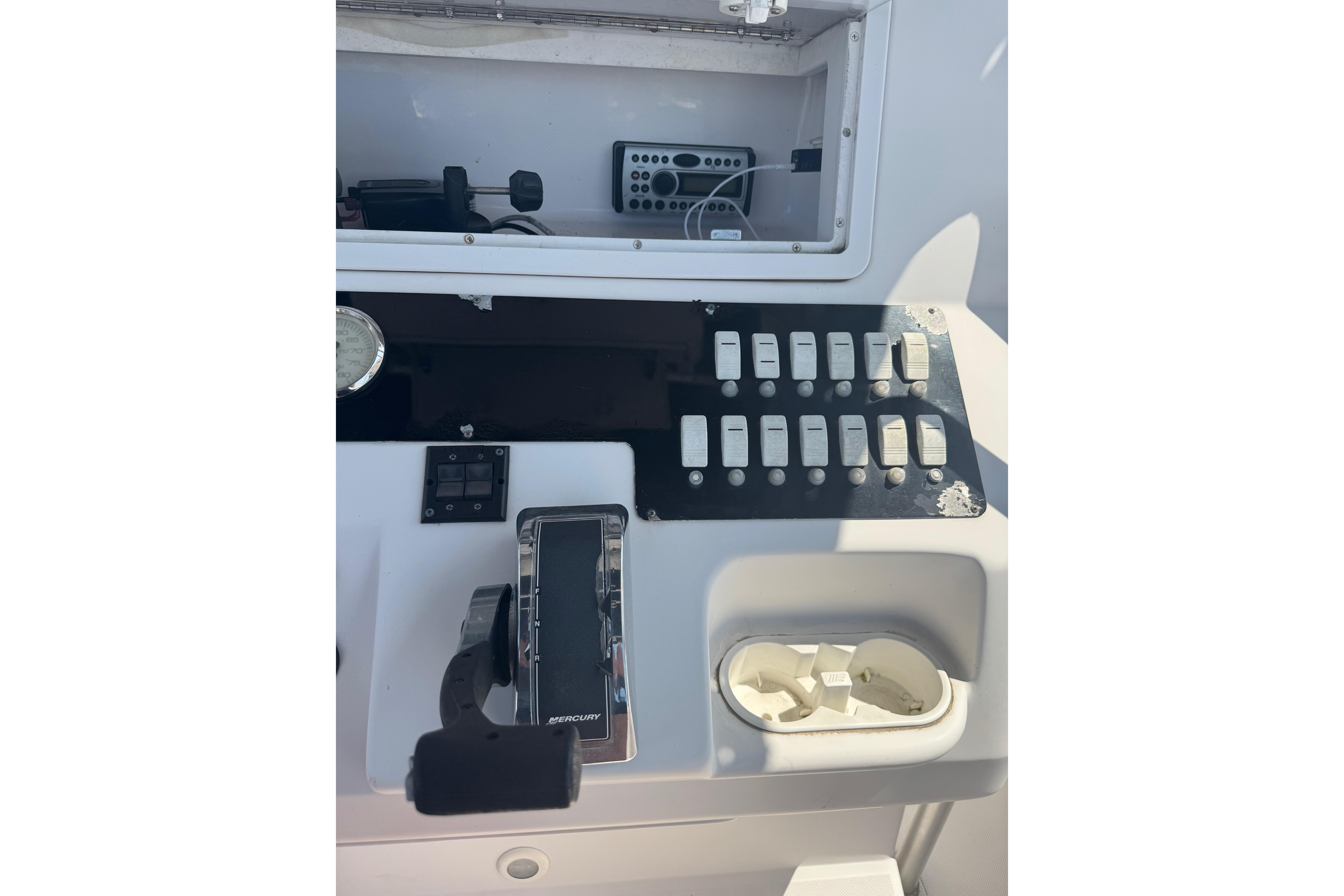 Control panel of a 2002 Pro-Line 23 Sport boat with switches and throttle.
