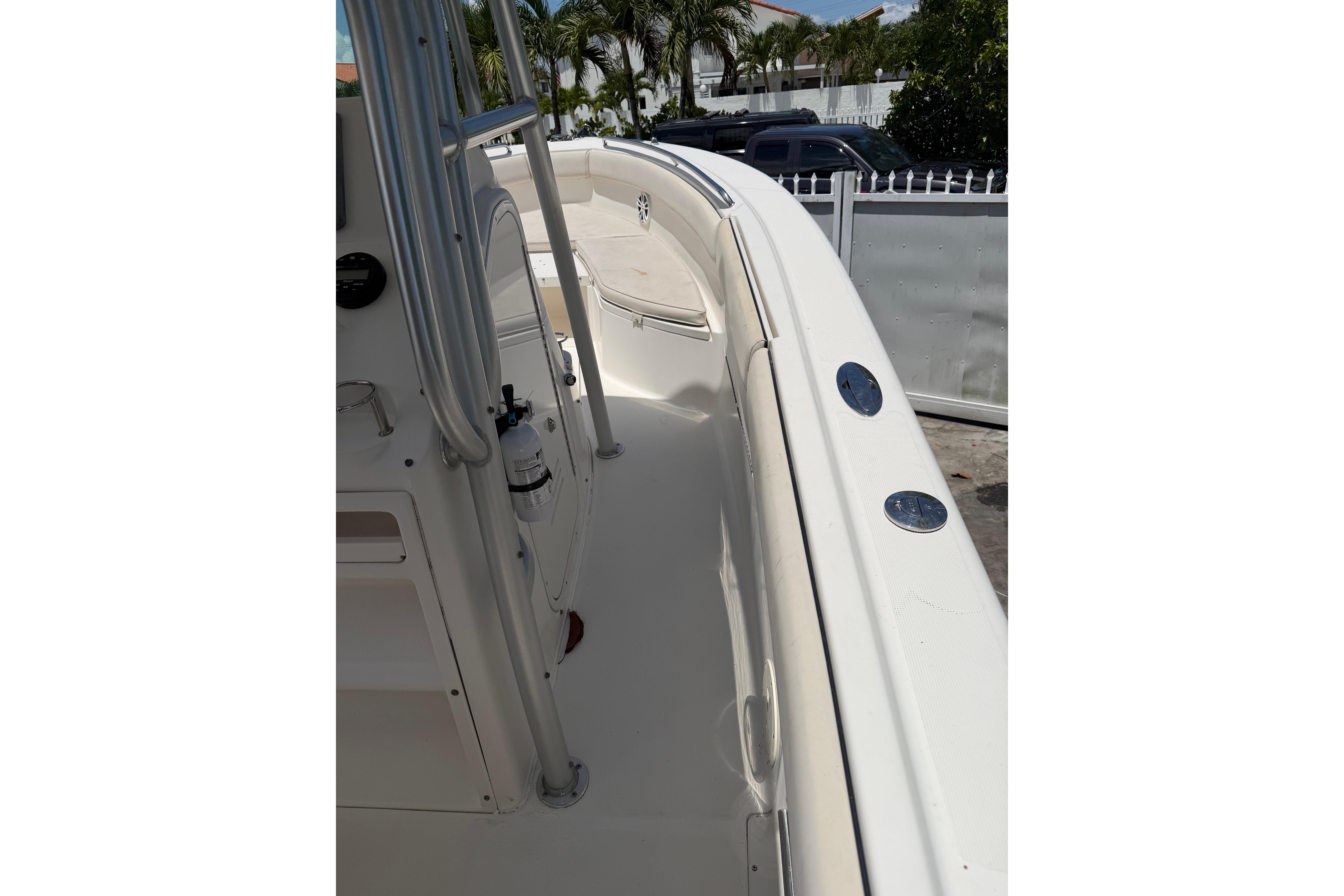 2007 Robalo R260 Center Console boat deck with railing and seating area.