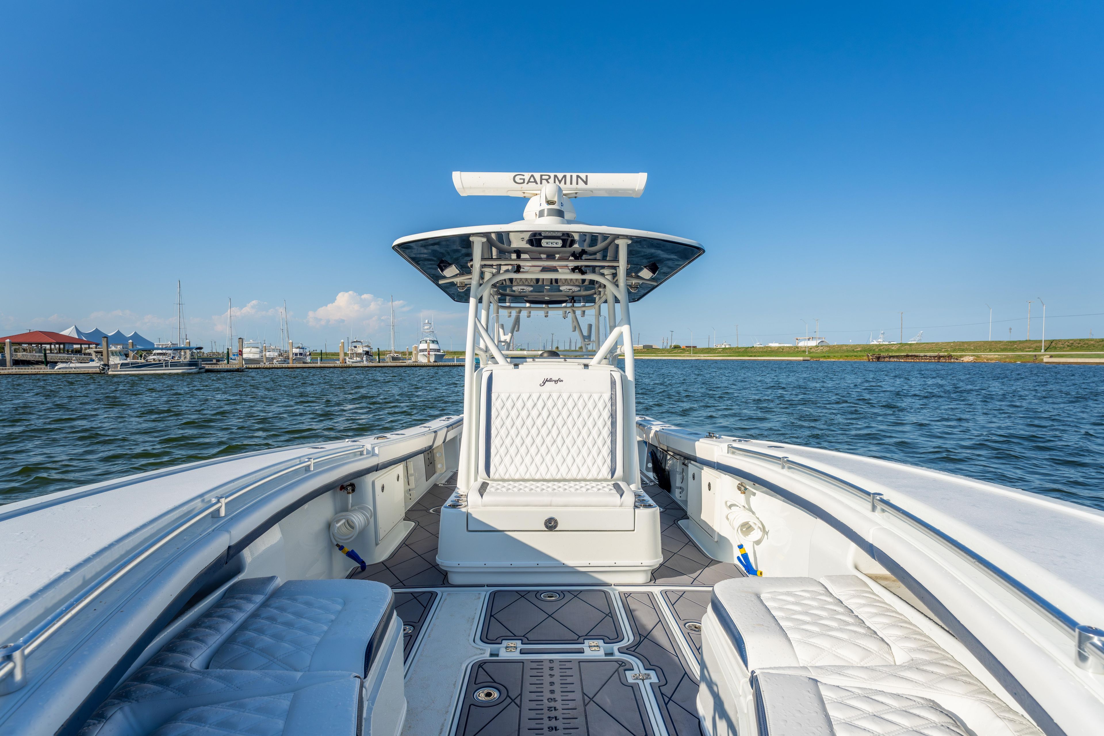 2021 Yellowfin 32 Offshore boat on water, featuring sleek design and advanced navigation equipment.