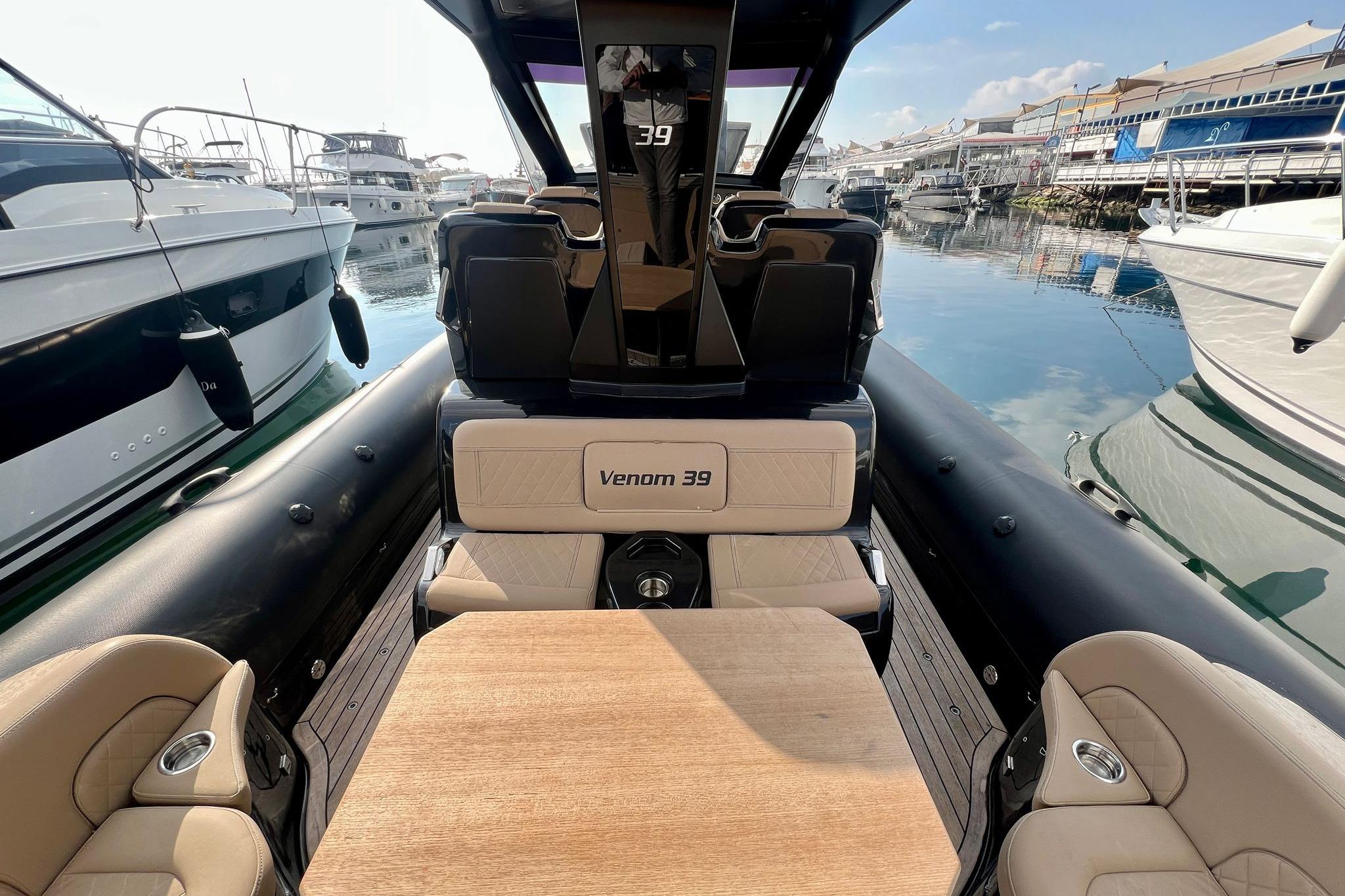 2022 Ribco Venom 39 luxury boat interior with seating and table, docked at marina.