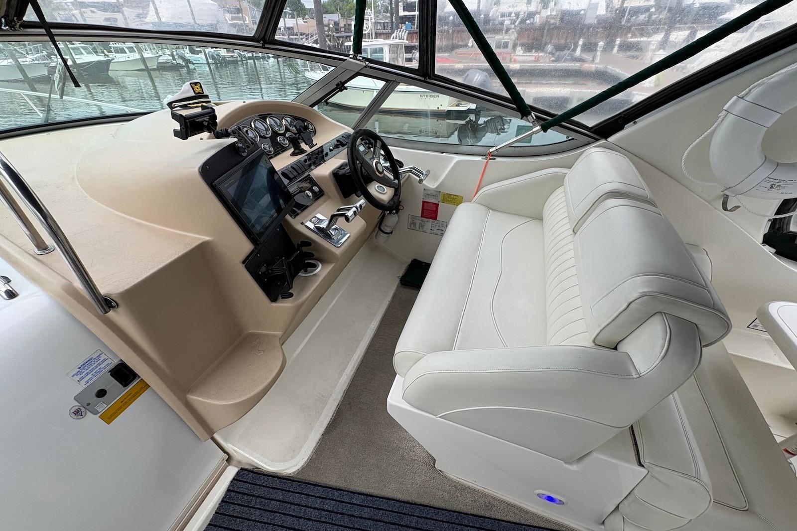 1999 Cruisers Yachts 3375 Esprit helm with white seating and modern controls.