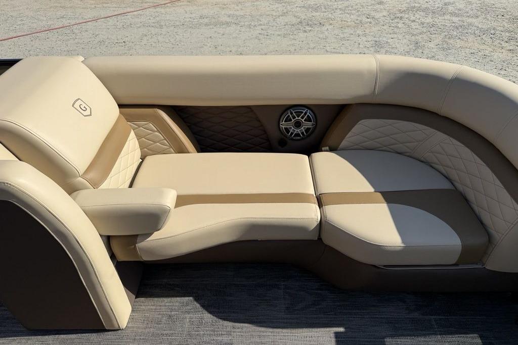 Luxurious seating on 2026 Godfrey Monaco 235 SB boat, featuring beige upholstery and quilted accents.
