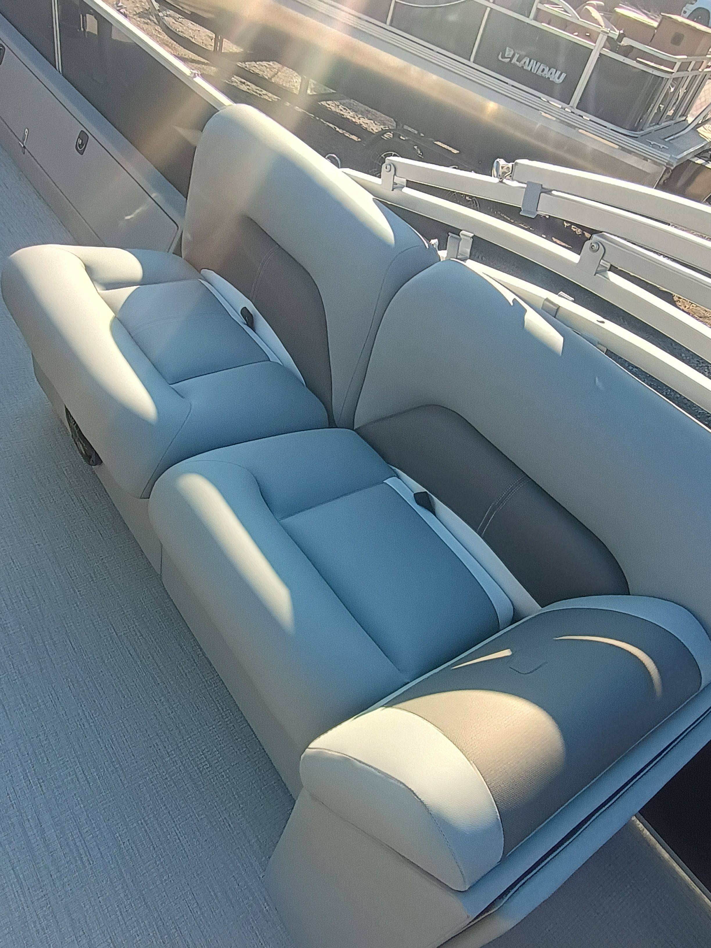 2026 Landau Alure 25CC Fish-Black boat seating in sunlight.