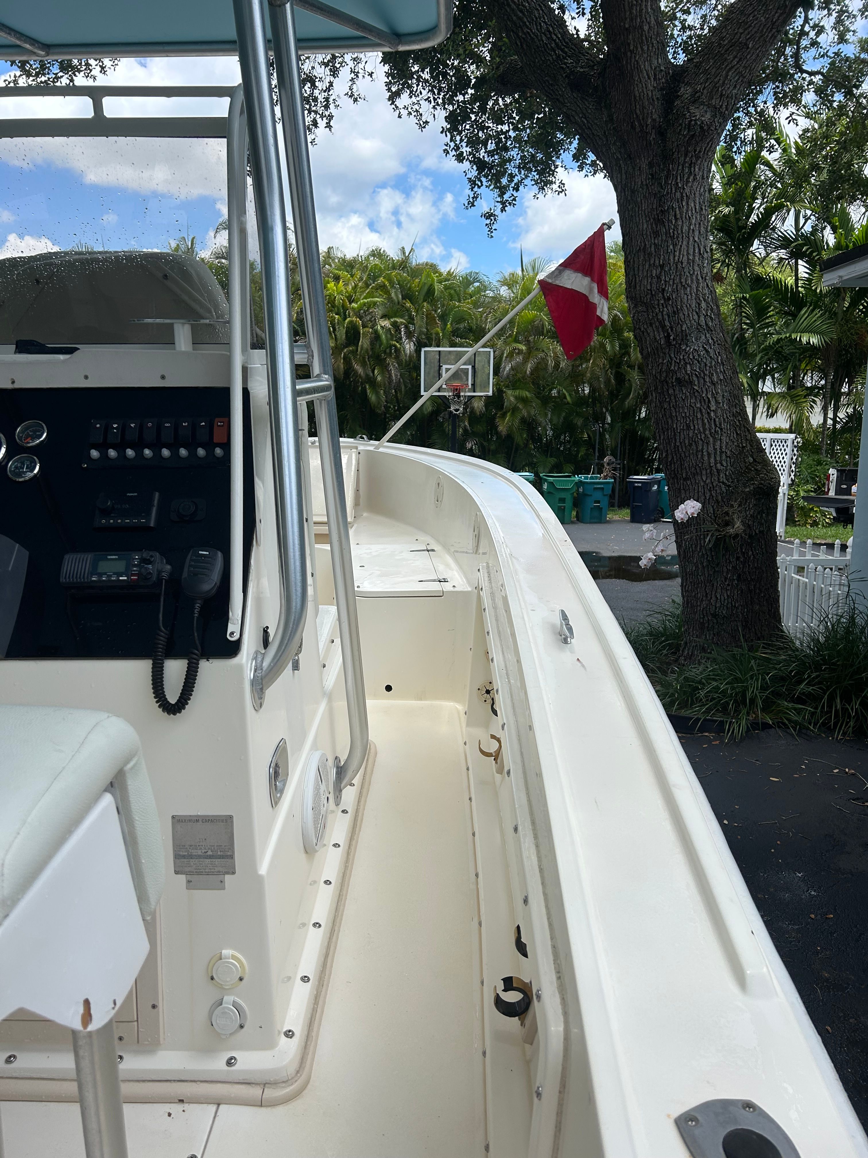 1992 Mako 221 boat with helm console, parked outdoors.