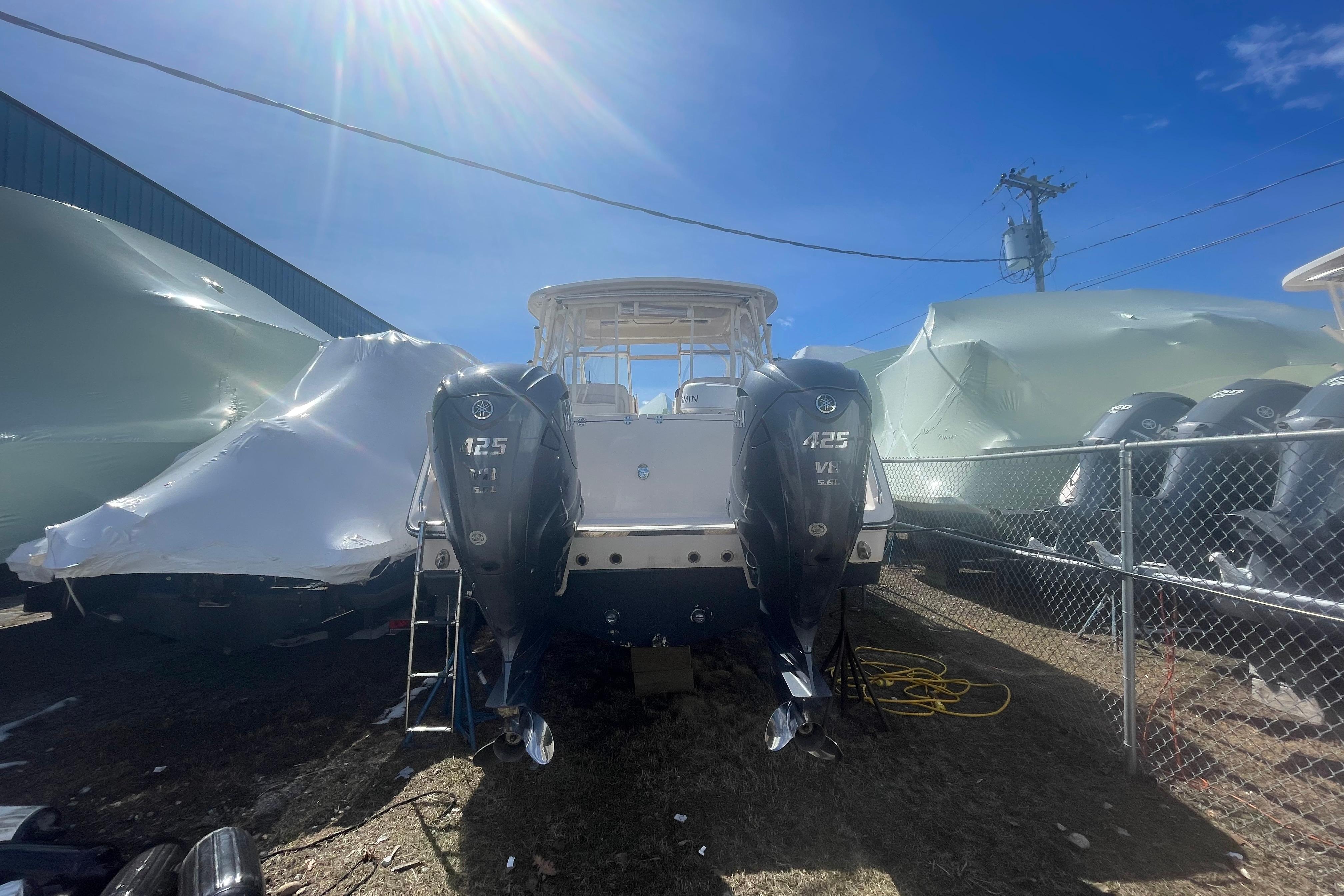 2023 Grady-White Freedom 335 boat with twin 425 V8 engines in storage yard.