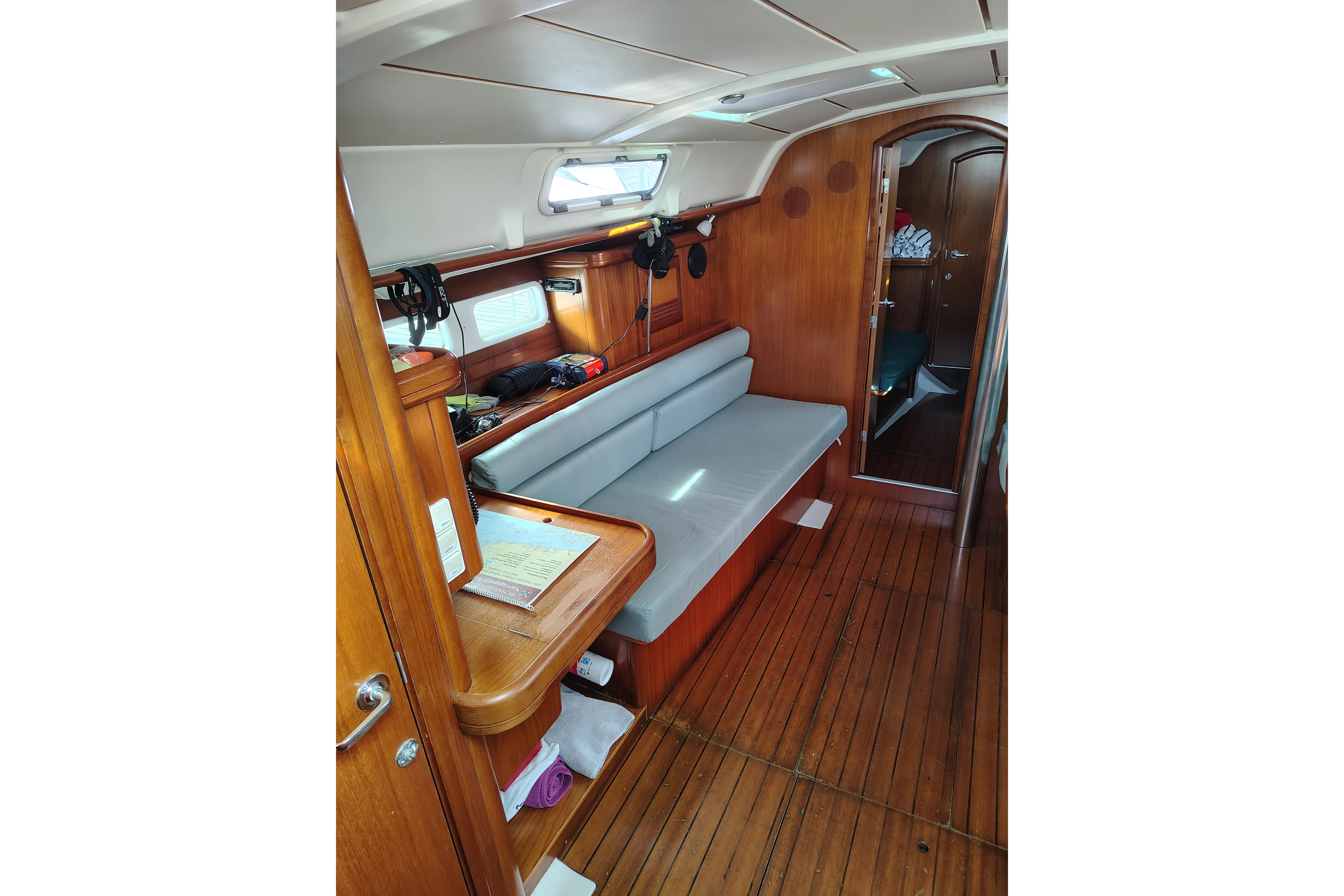Interior of 2001 Beneteau Oceanis 411 sailboat with wooden flooring and seating area.