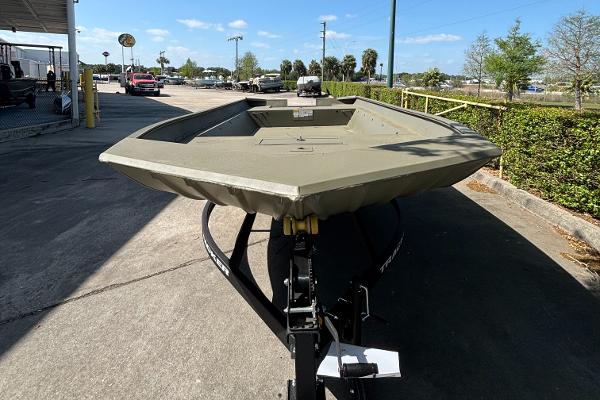 2025 Tracker GRIZZLY 2072 Utility boat on trailer, parked outdoors.