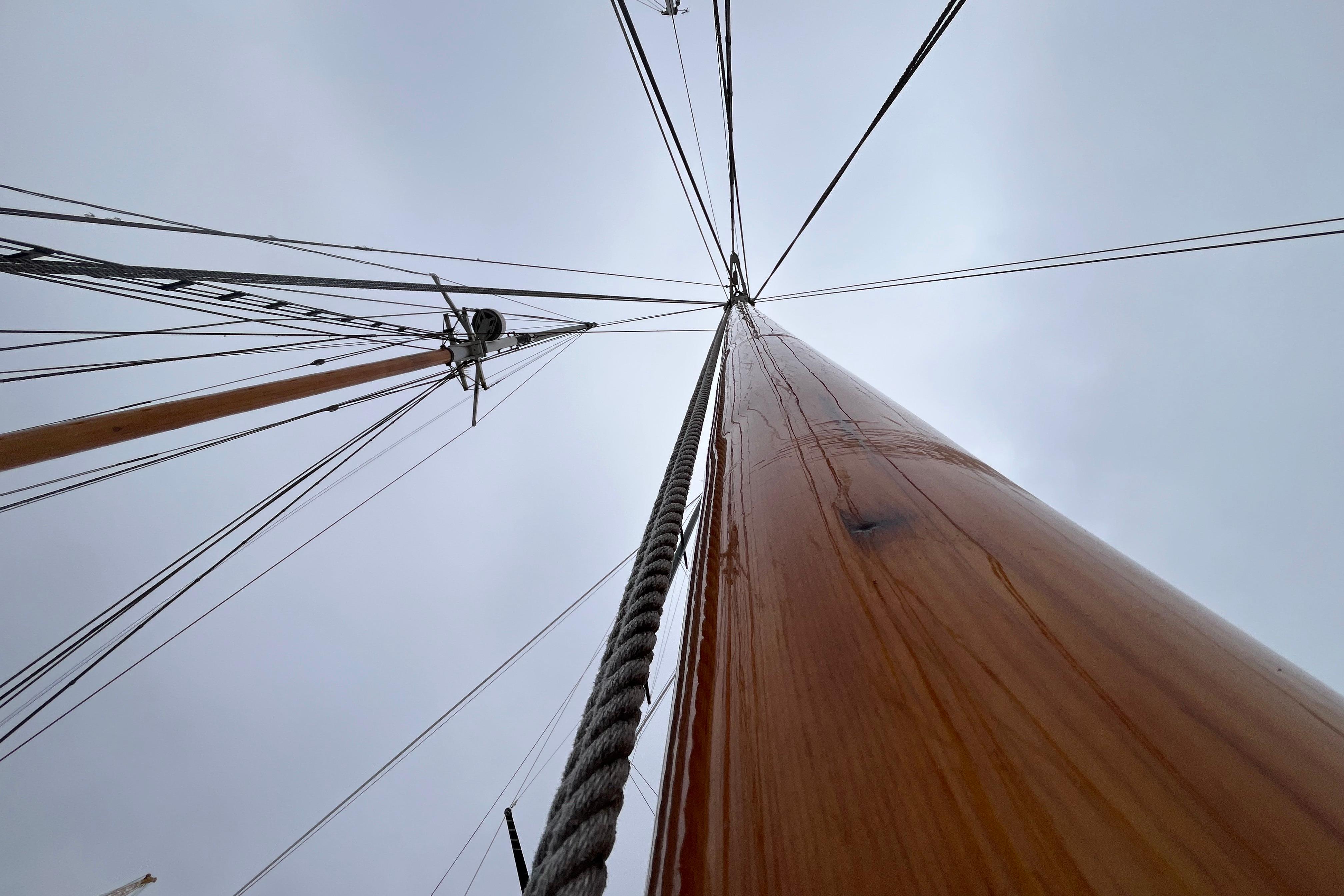 View of schooner mast and rigging against cloudy sky, Murray Peterson model, 1947.