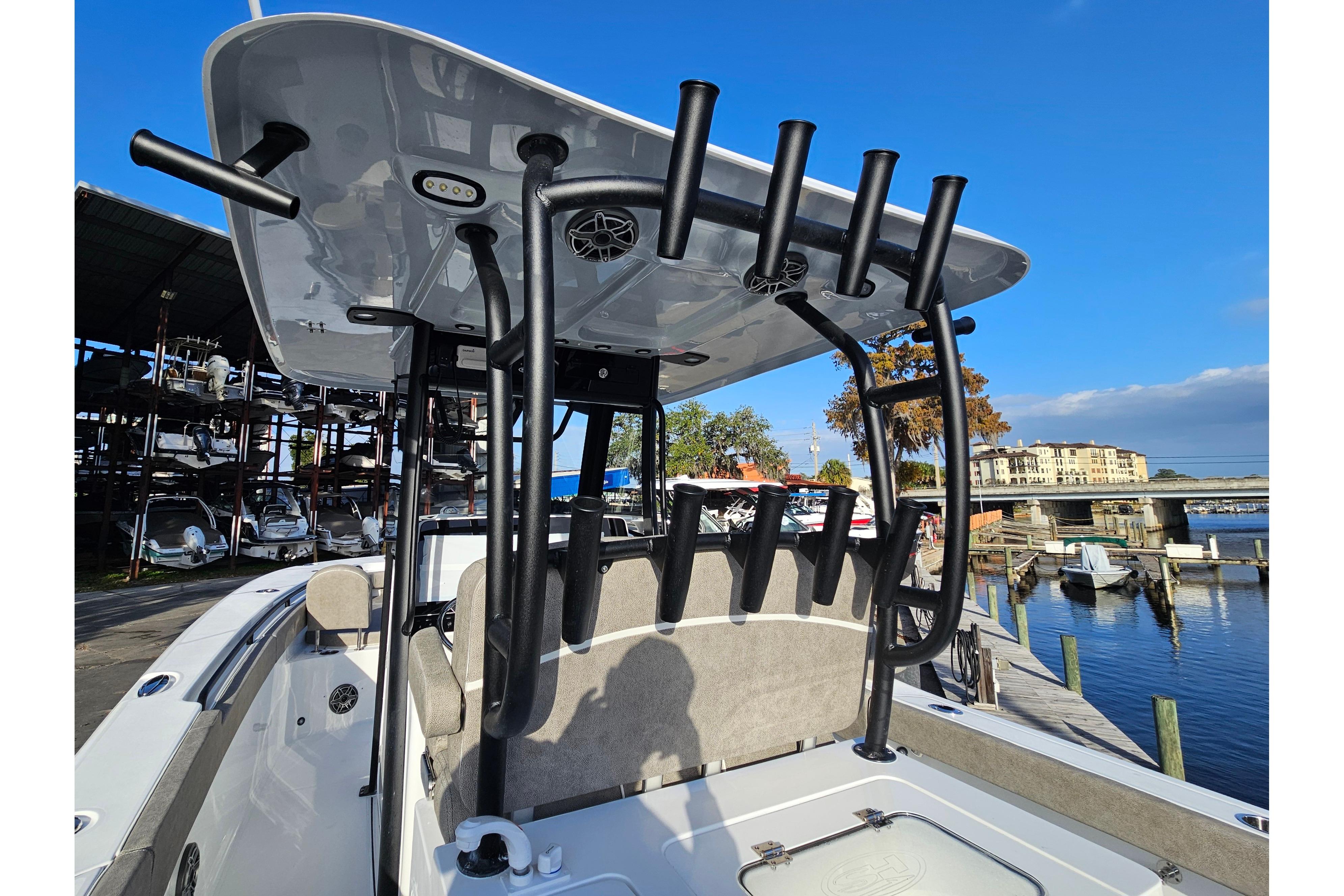 2026 Sea Hunt Ultra 285 SE boat with rod holders, docked at a marina.