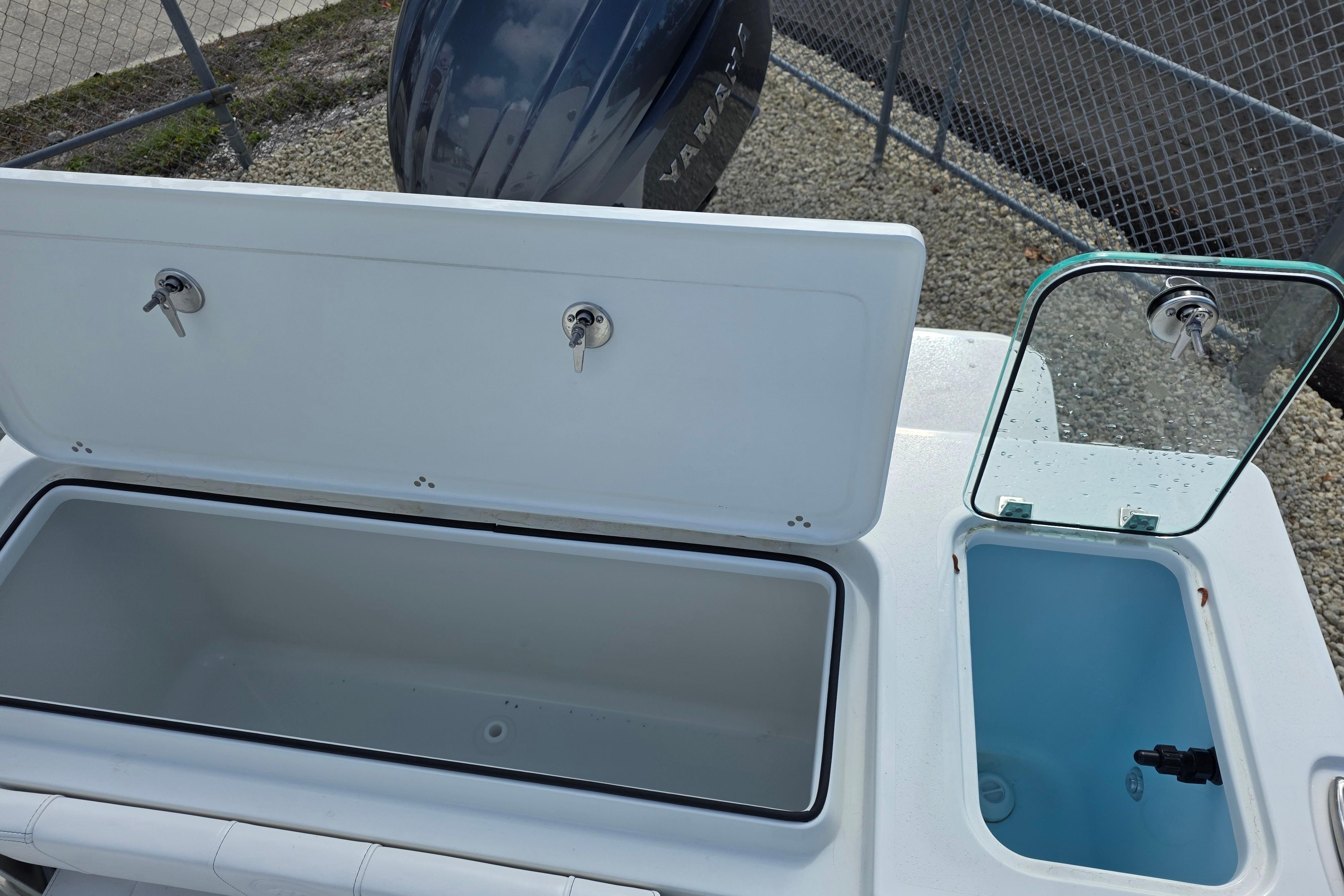 Open storage compartments on a 2026 Parker 227 Explorer boat, showcasing utility and design.