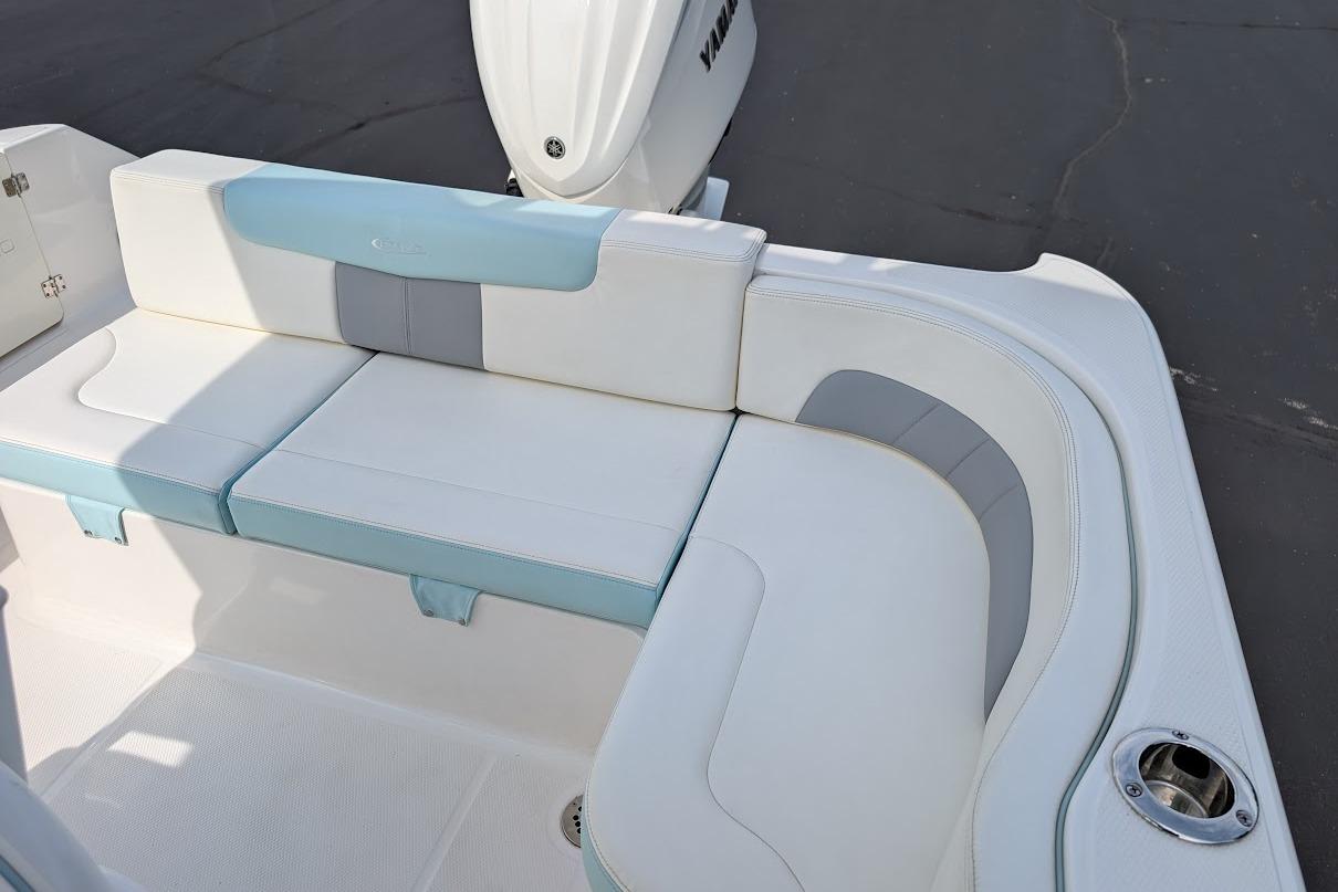 2022 Robalo R242 Explorer boat seating area with white and blue cushions.